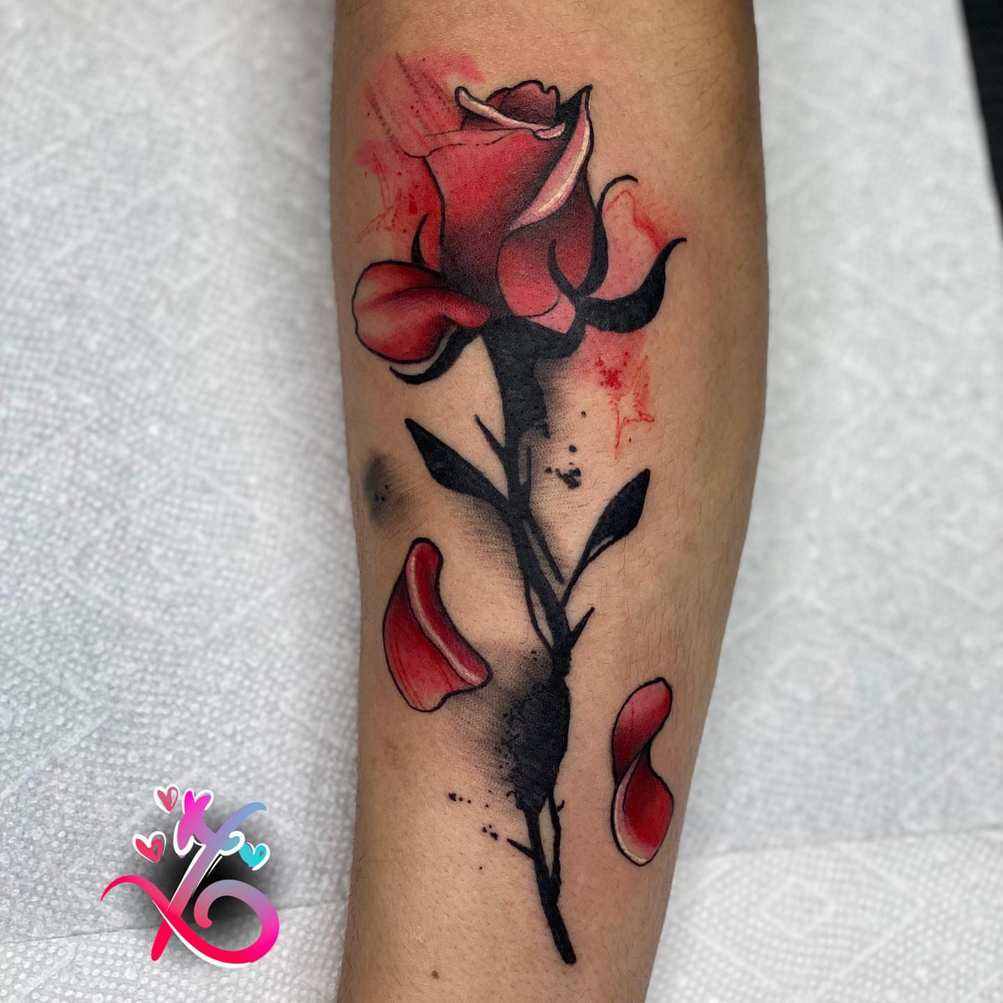 Red rose watercolor tattoo on the forearm by Keyon J