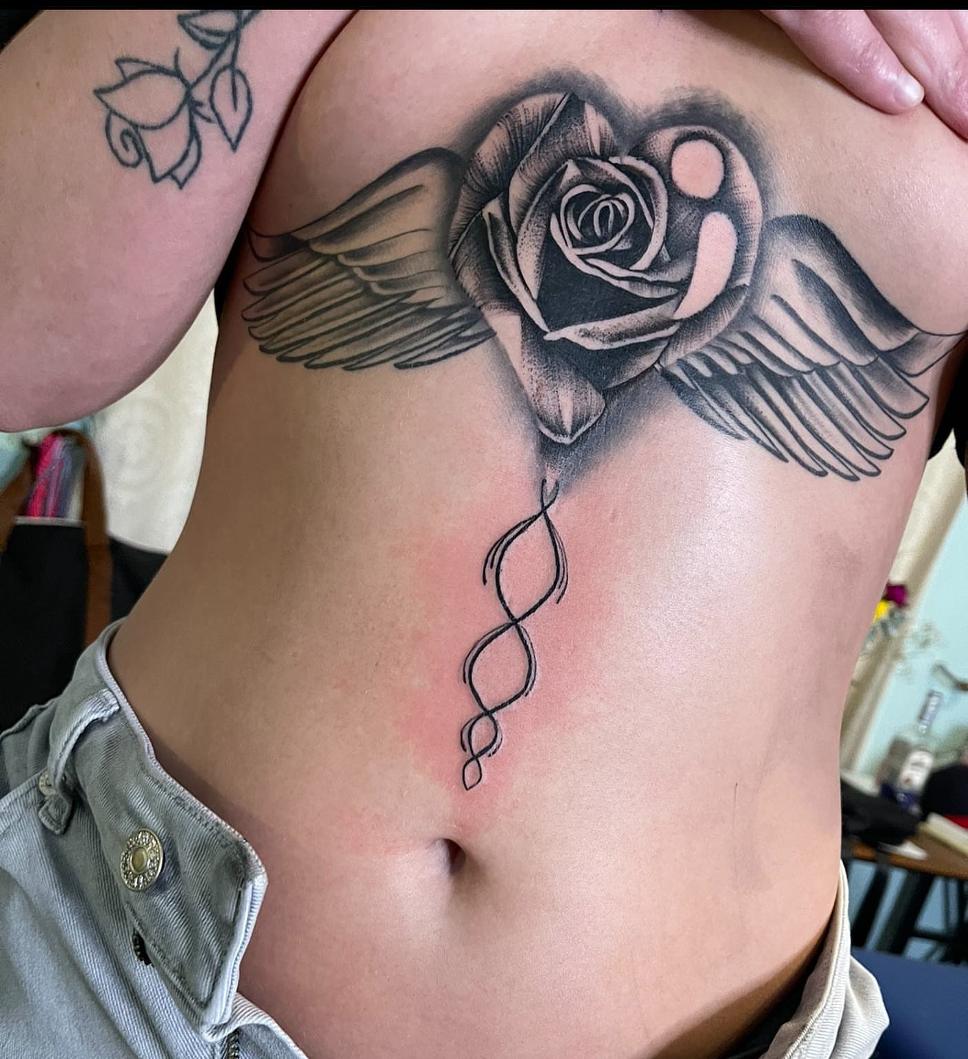 Winged rose realism tattoo on the ribs by Las Vegas Tattoo Artist