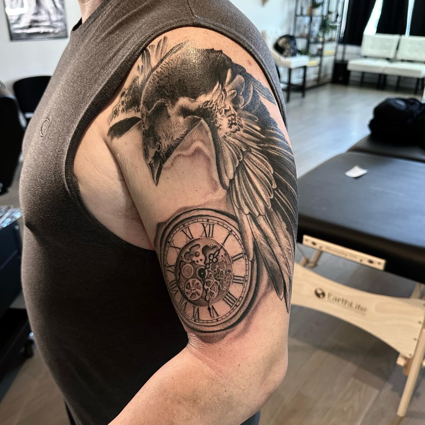 Crow and clock realism tattoo on the shoulder by Matthew Clanin