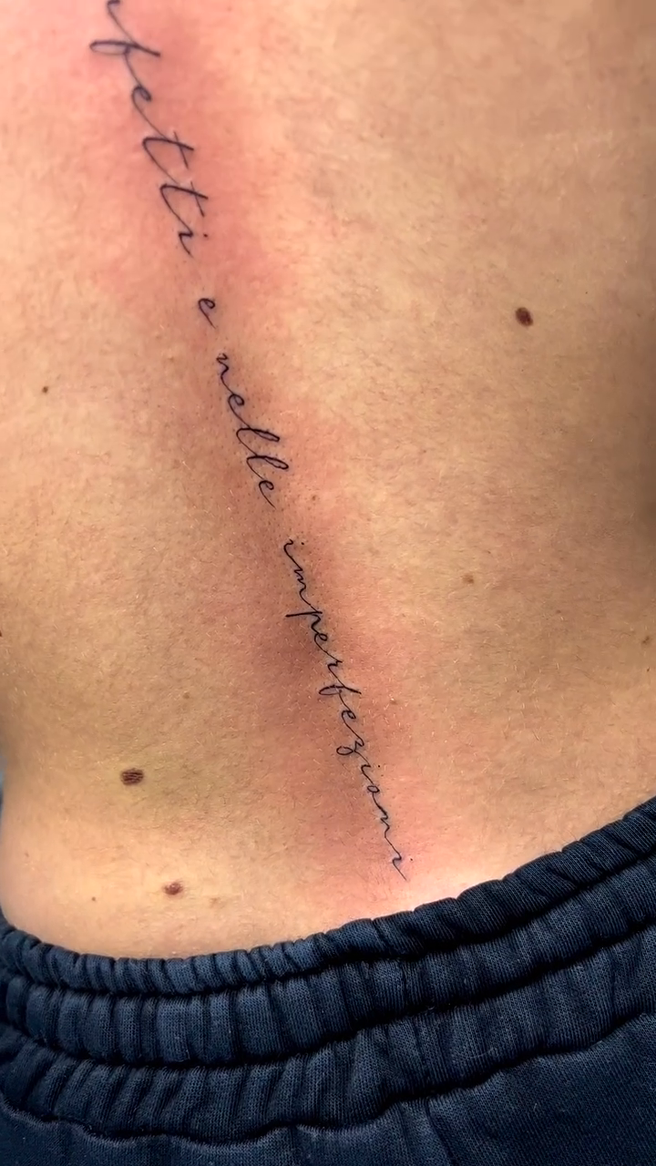 Spine script tattoo lettering tattoo on the back by Takyro