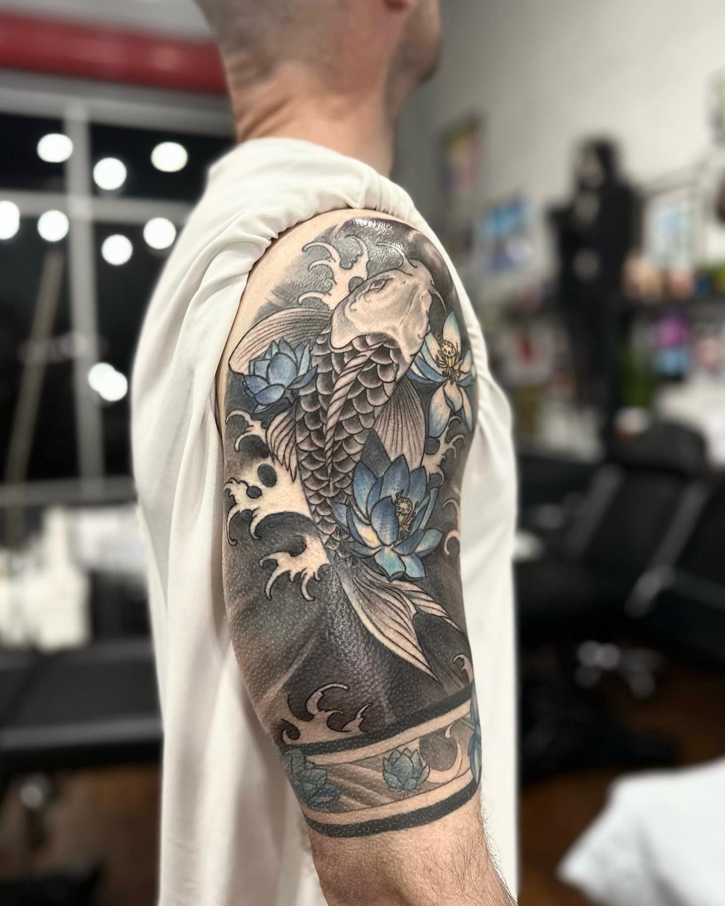 Koi fish and lotus flowers japanese irezumi tattoo on the forearm by Oxana