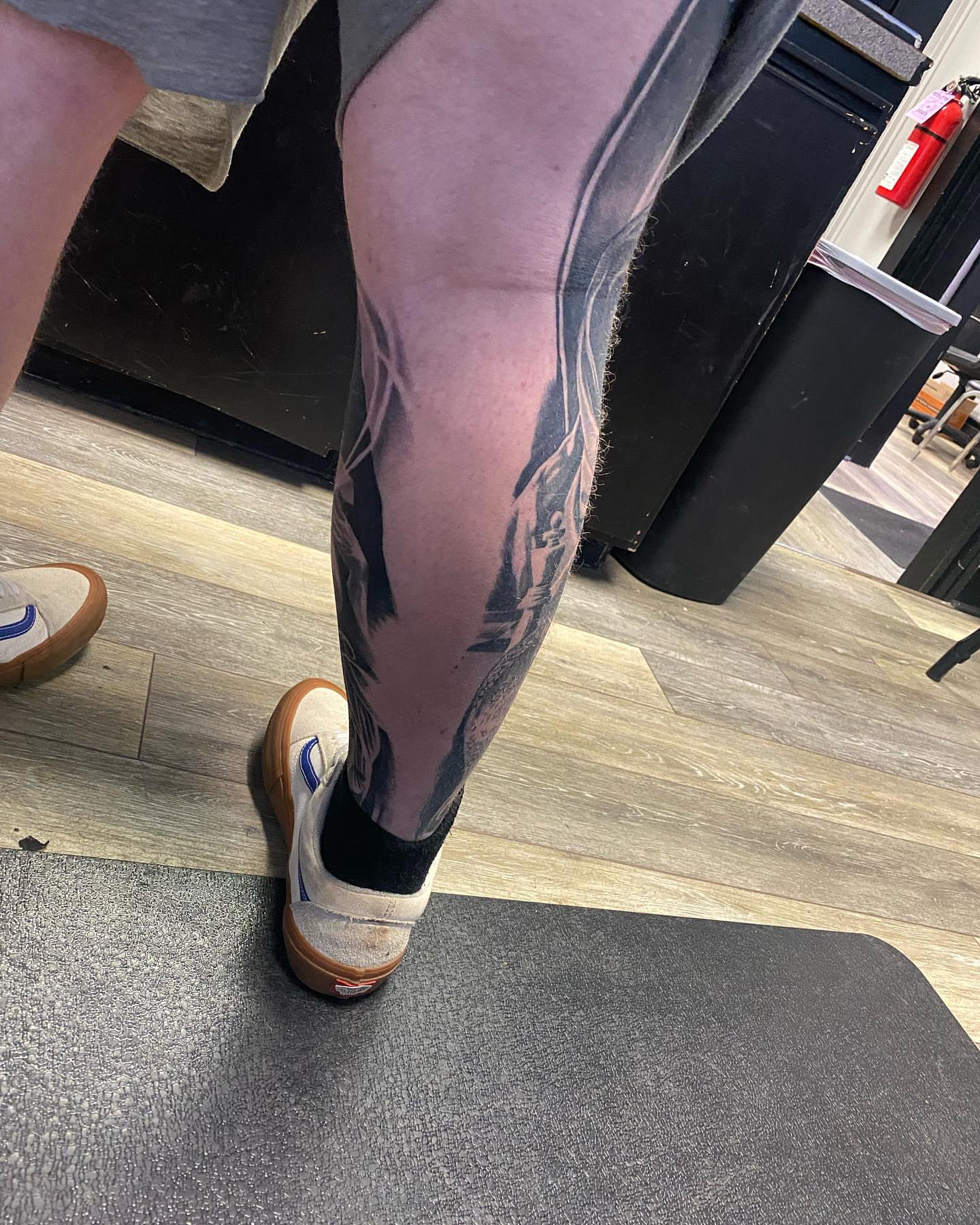 Floral design black and grey tattoo on the leg by Brian Cassidy