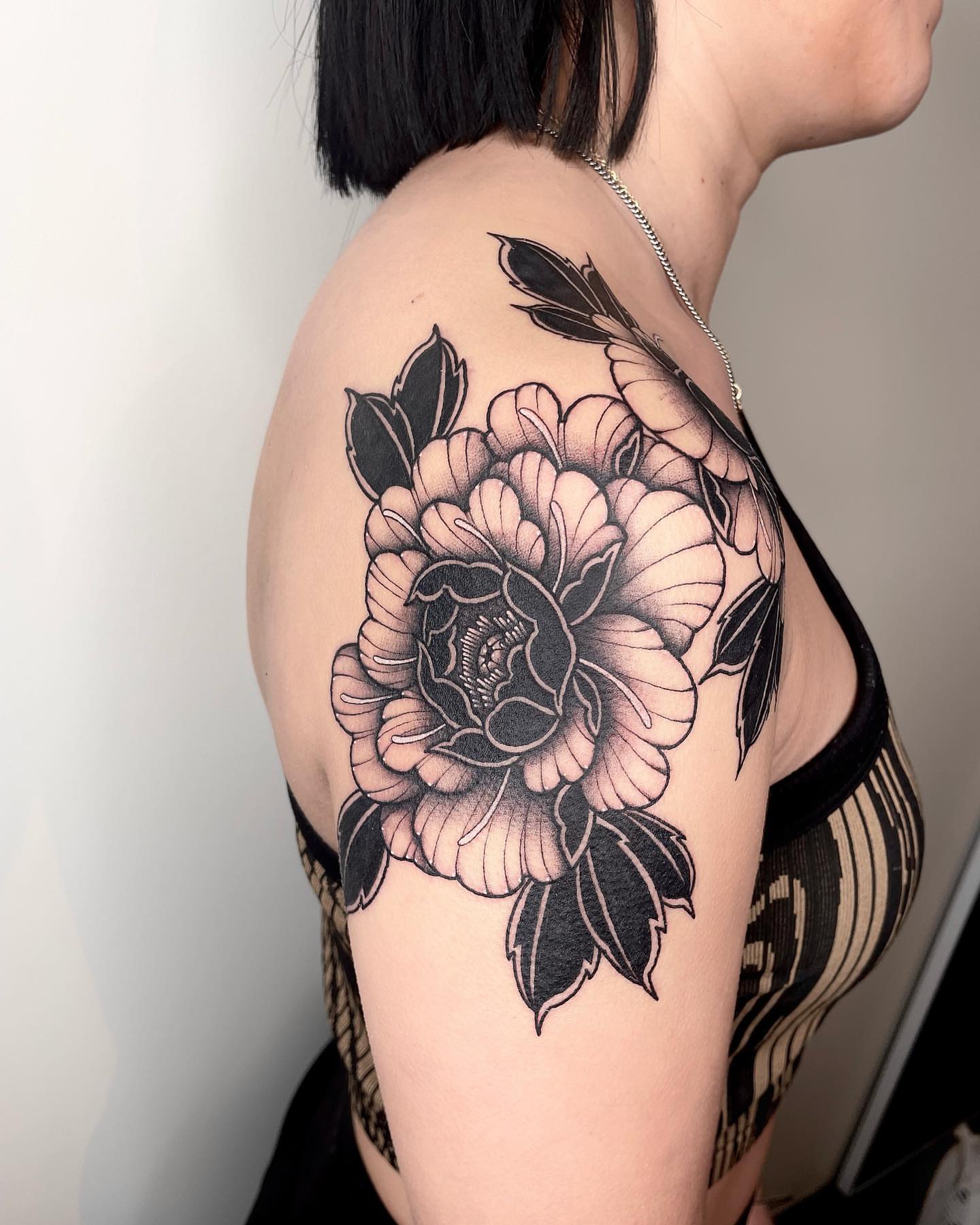 Peony black and grey tattoo on the shoulder by LA tattoo