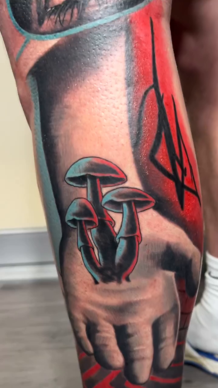Hand holding mushrooms realism tattoo by Krys King Tattoos