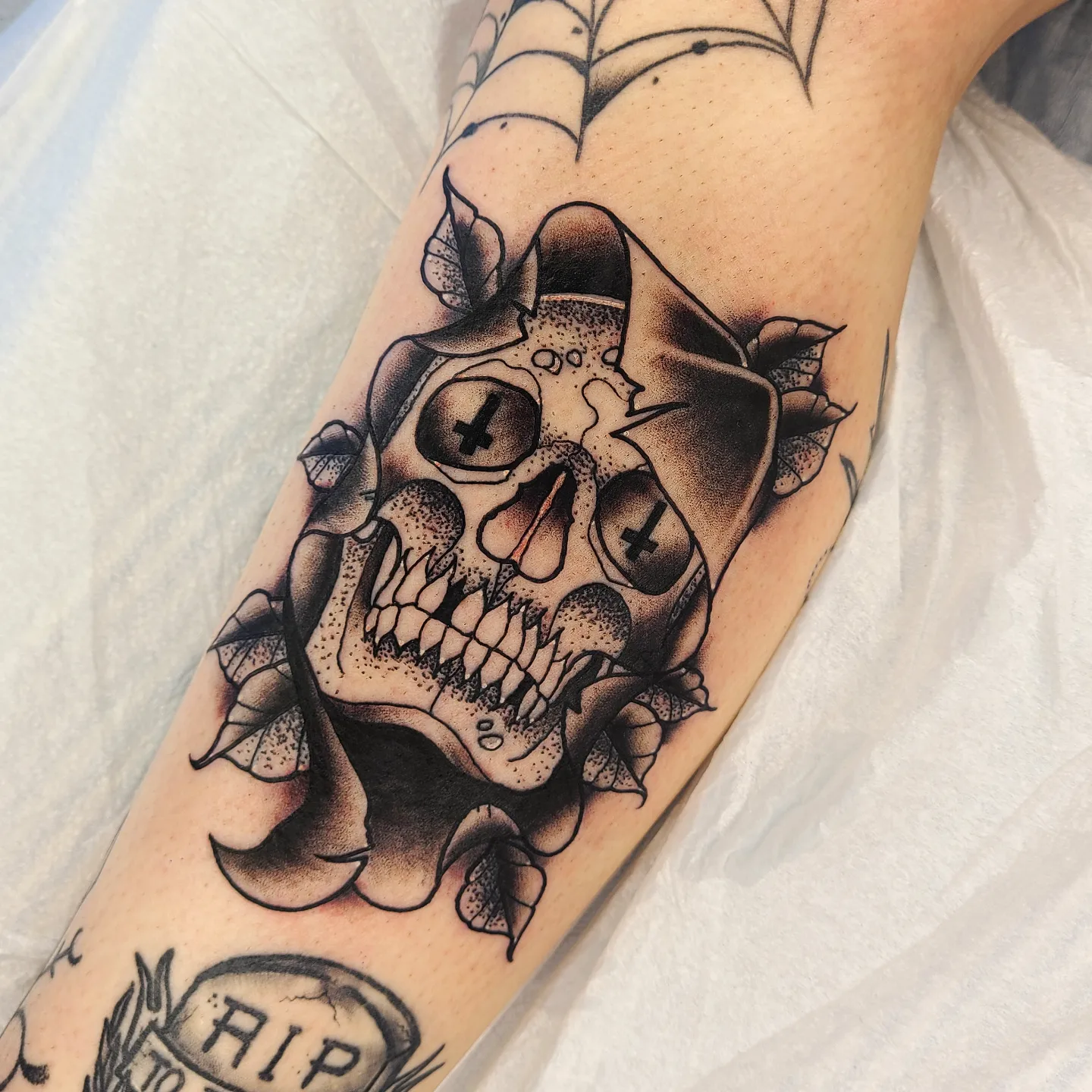 Skull black and grey tattoo on the forearm by Noah Crow