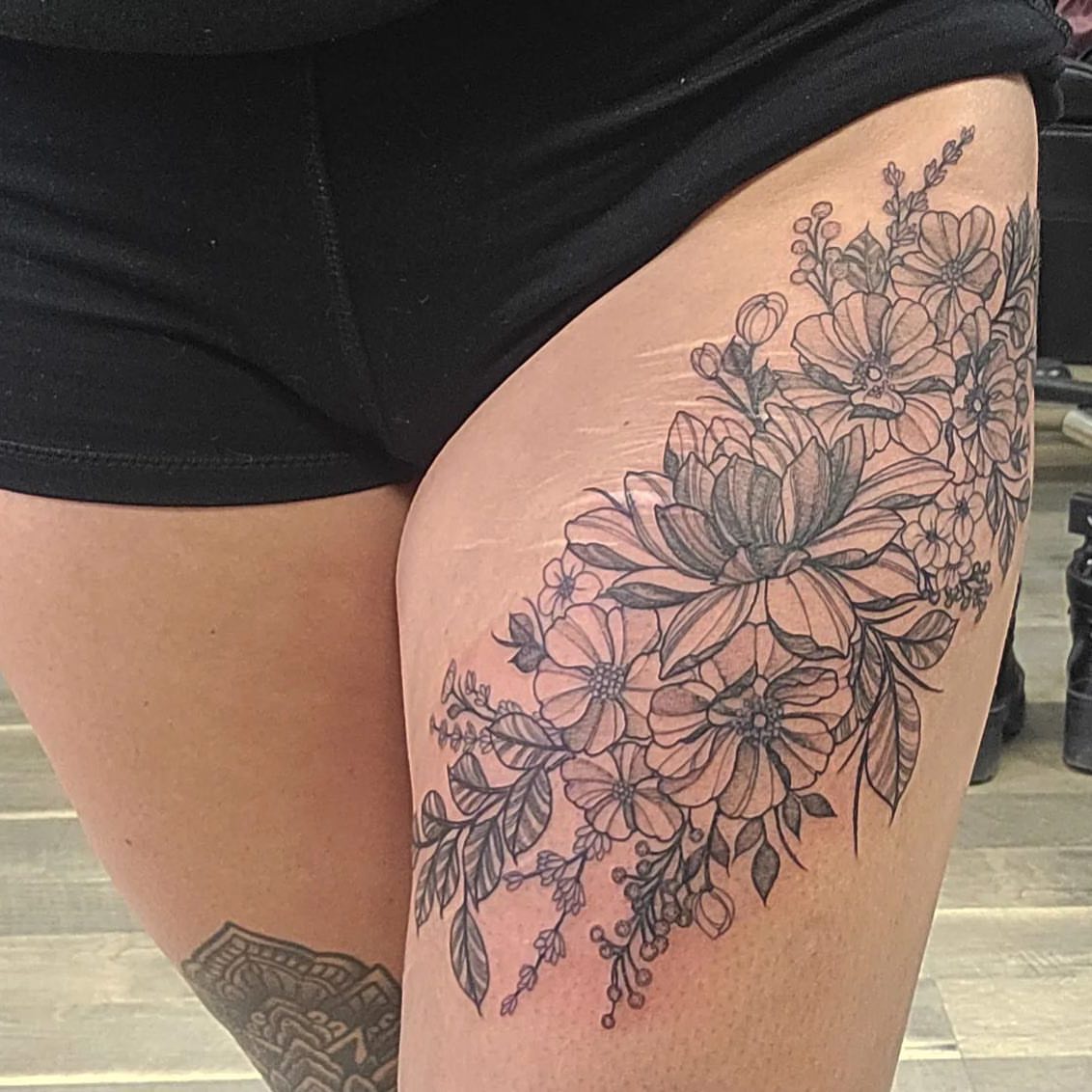 Floral bouquet black and grey tattoo on the thigh by 𝕵𝖊𝖘𝖘𝖆 𝕭𝖎𝖌𝖊𝖑𝖔𝖜, Harrison, New Jersey