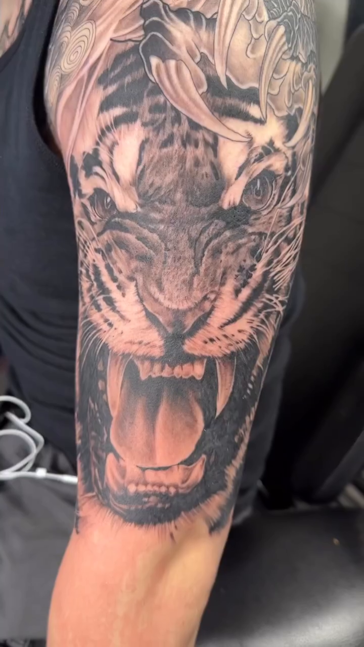 Tattoo by @vudoo_tattoo — realism, black_and_grey