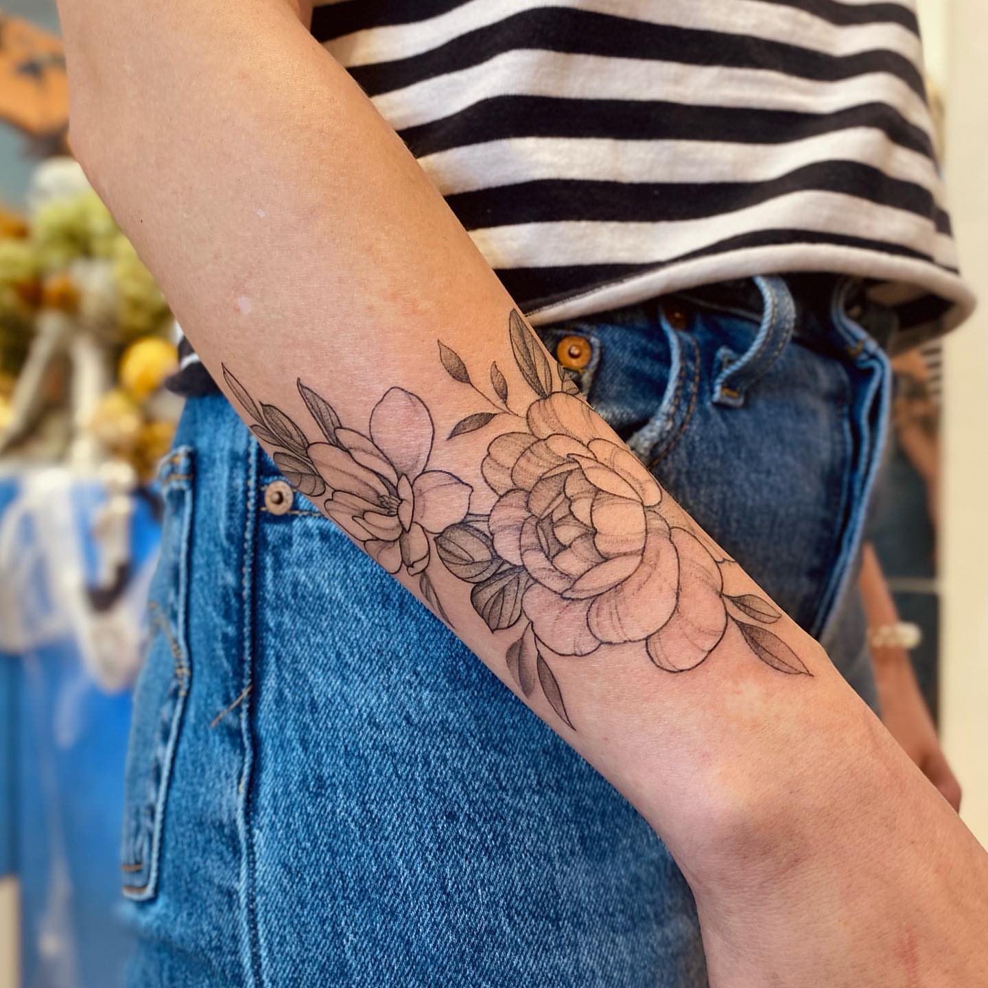 Floral arrangement black and grey tattoo on the forearm by 𝘉𝘢𝘺 𝘈𝘳𝘦𝘢 𝘛𝘢𝘵𝘵𝘰𝘰 𝘈𝘳𝘵𝘪𝘴𝘵, Oakland, California