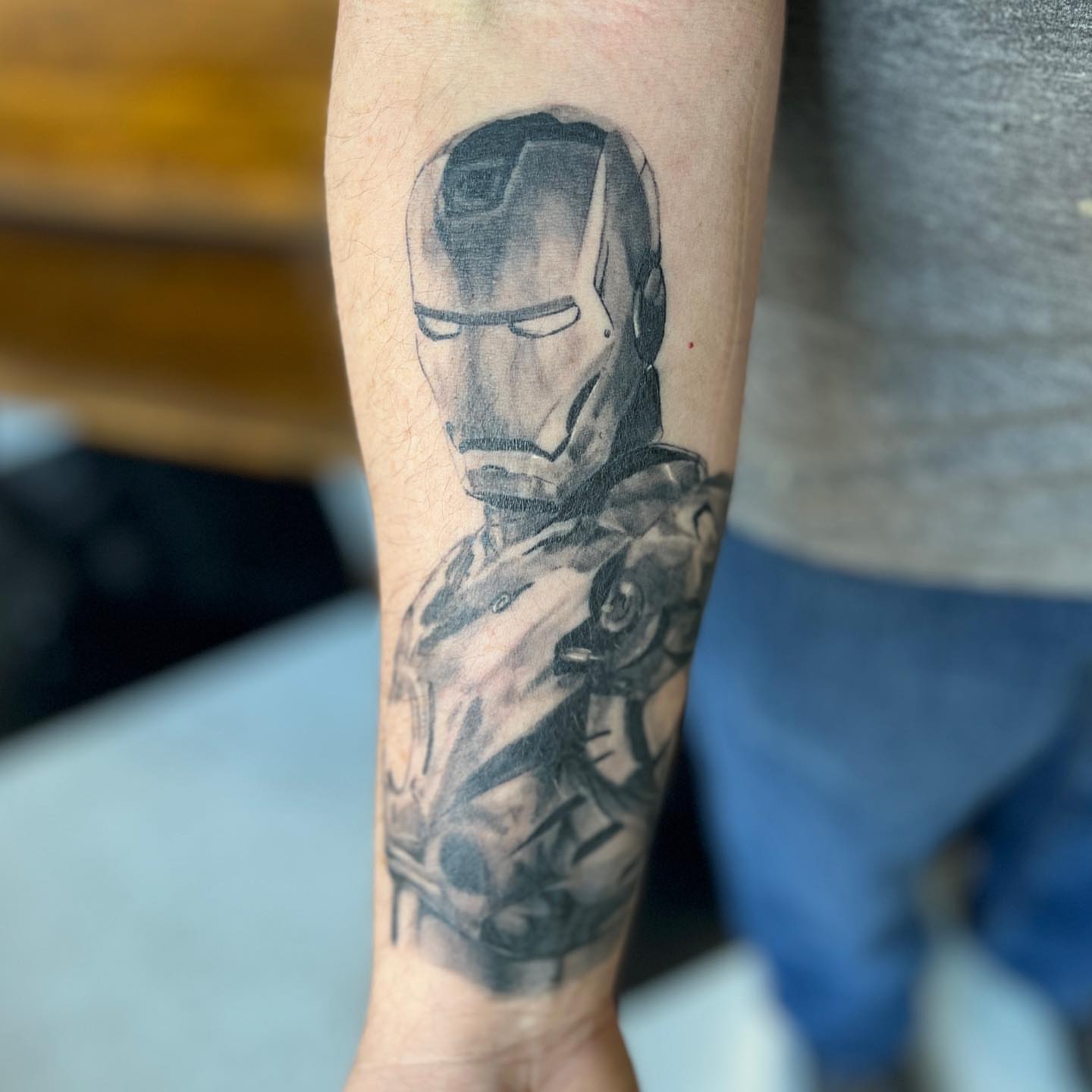 Iron man helmet black and grey tattoo on the forearm by Zachary Kaufhold