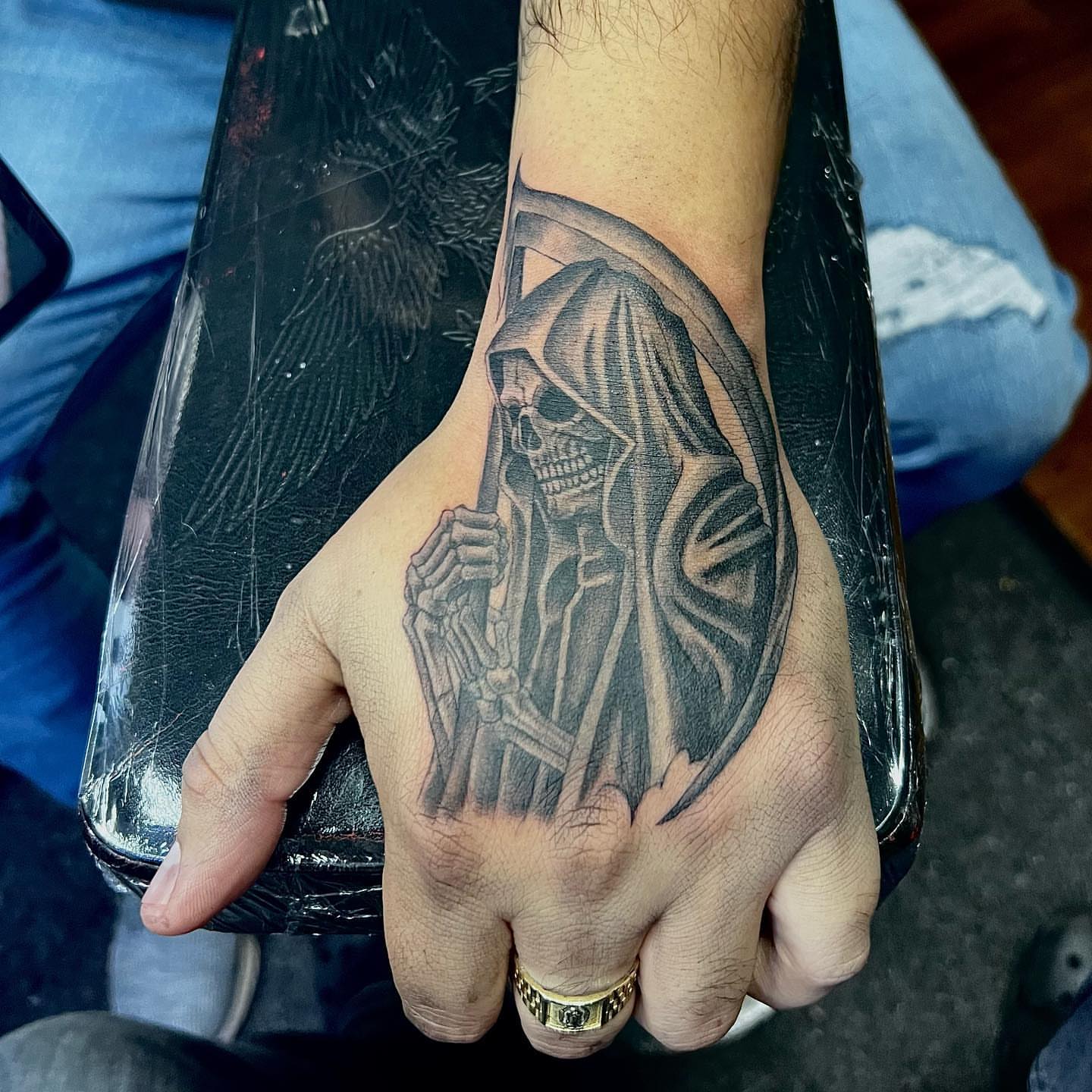 Grim reaper black and grey tattoo on the hand by JT Ink