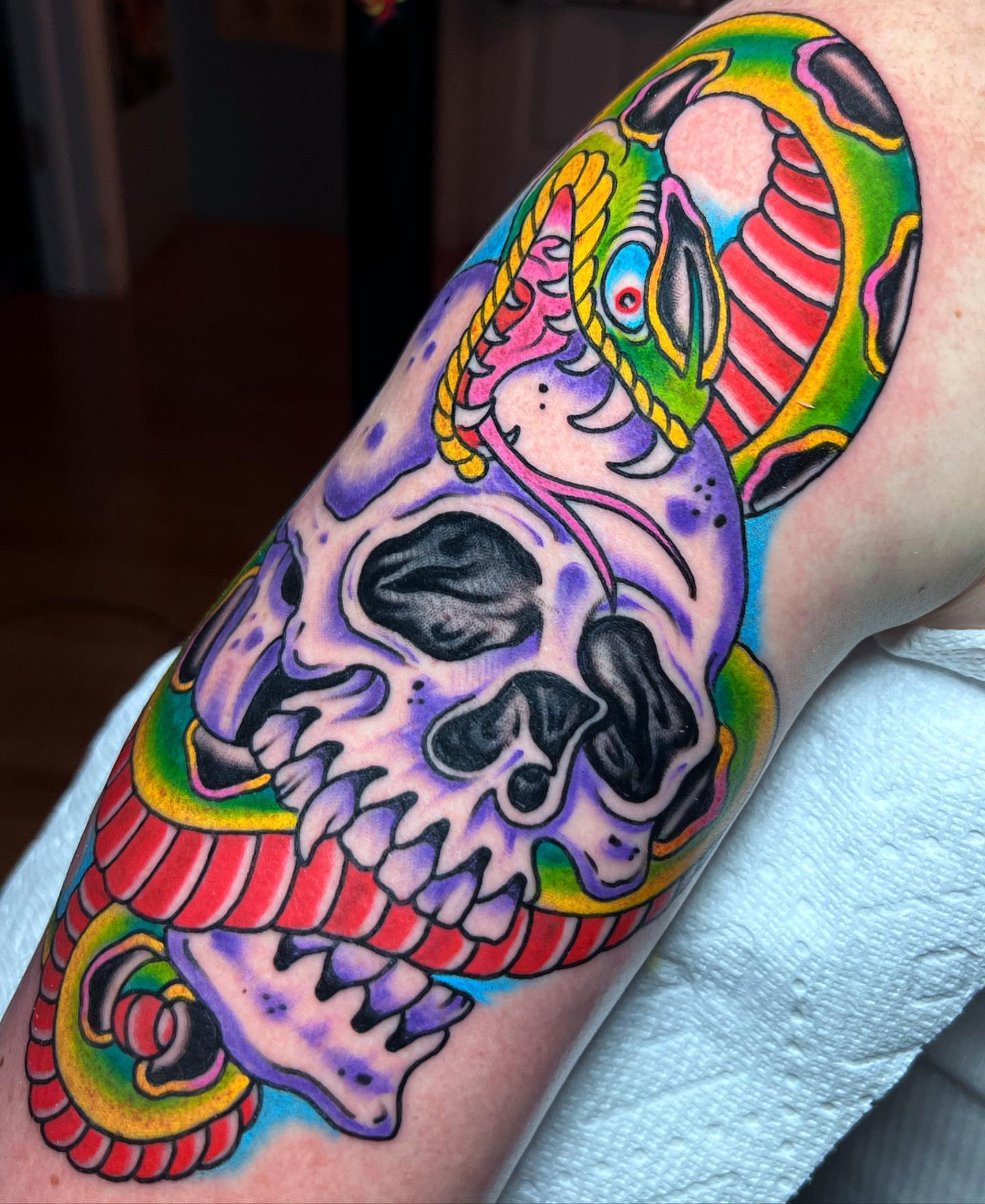 Skull with snake American traditional tattoo on the forearm by Barron