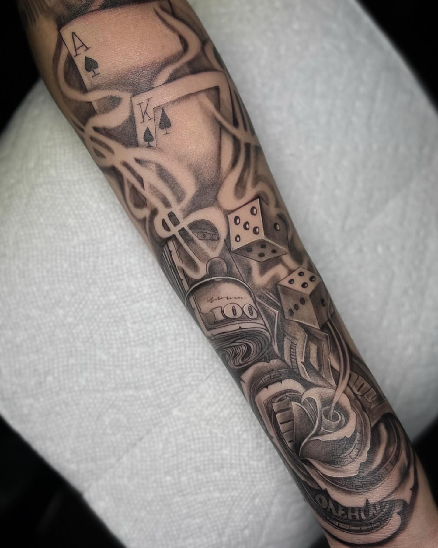 Cards and dice black and grey tattoo on the forearm by Nj Tattoo Artist Inkdyou, Bloomfield, New Jersey