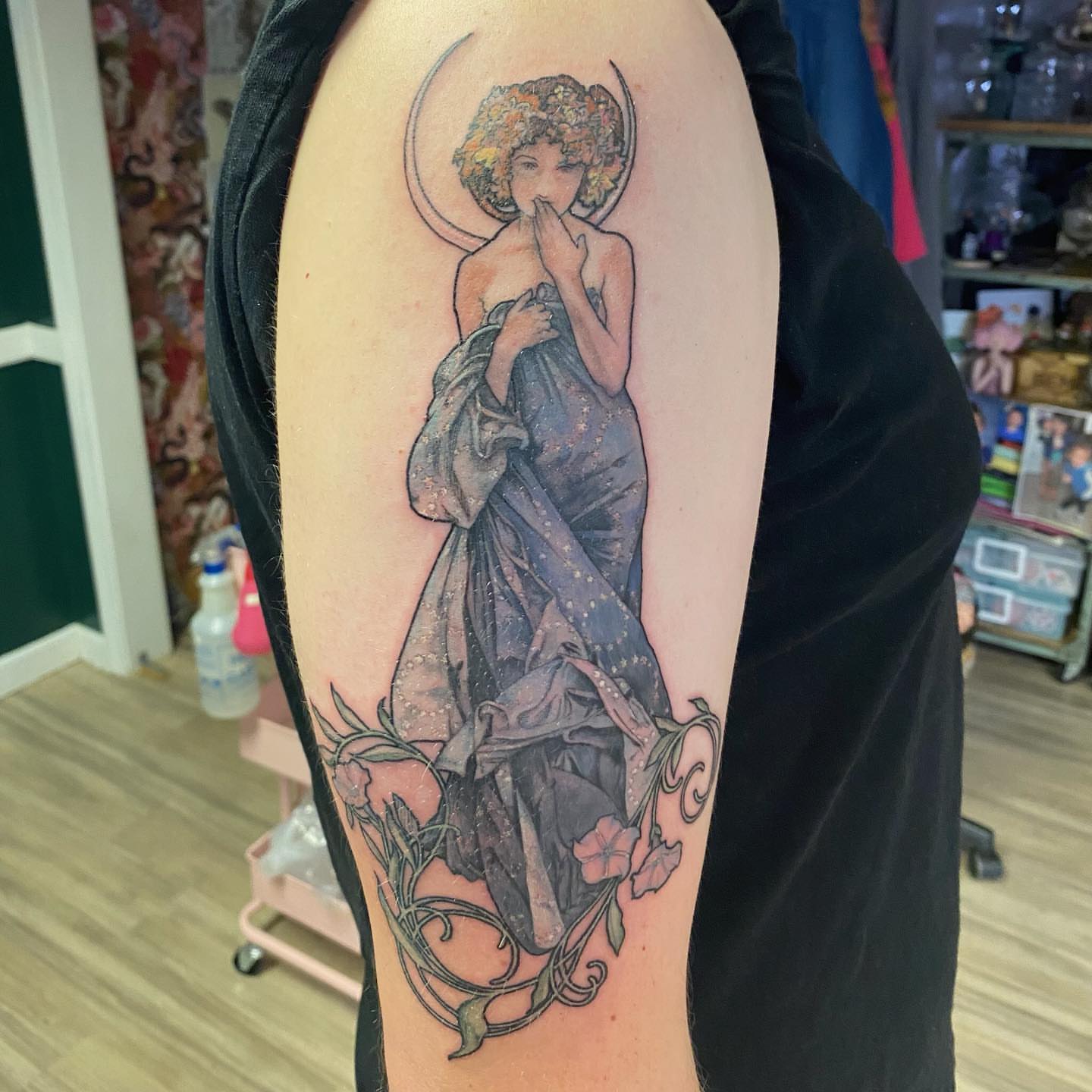 Woman in dress illustrative tattoo on the upper arm by Emily Conner