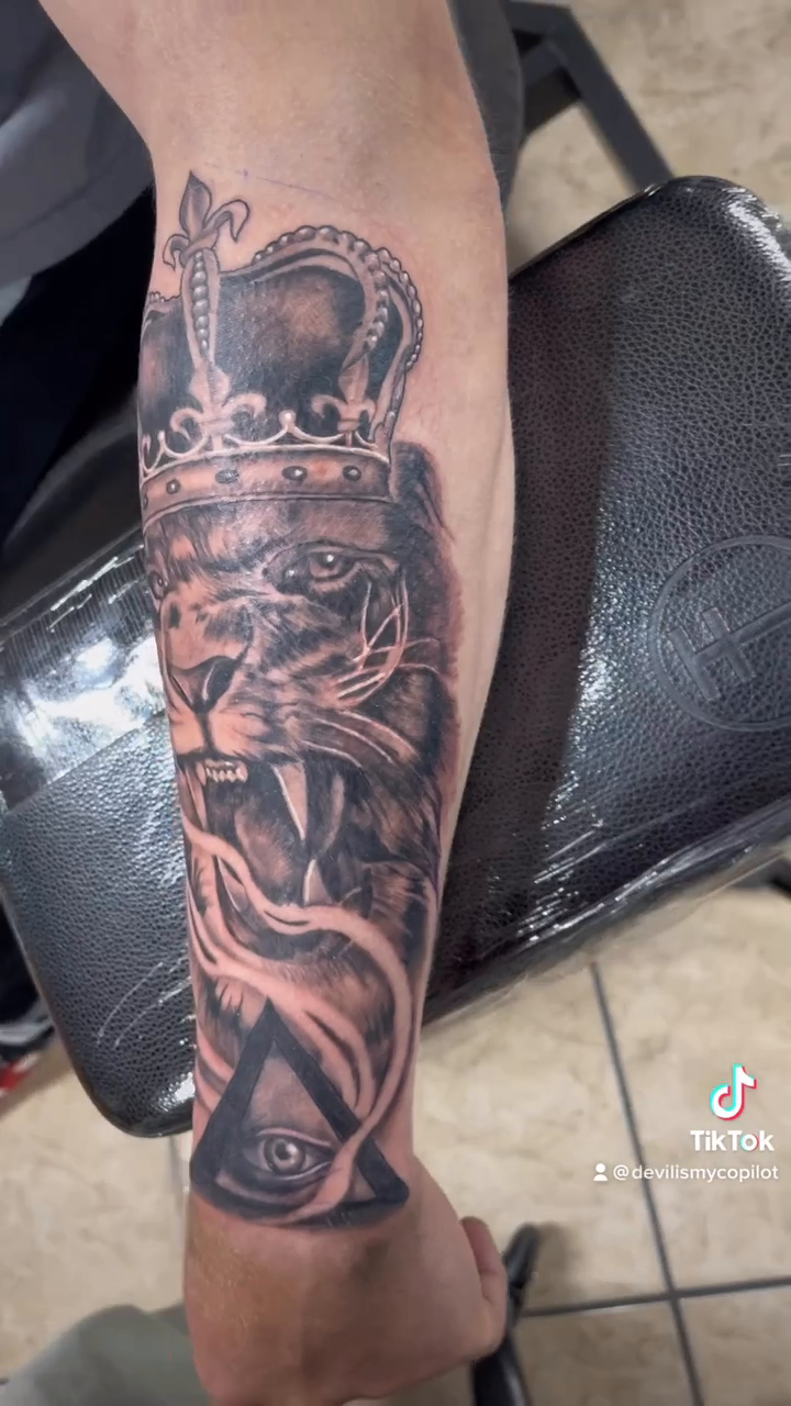 Lion with crown and eye realism tattoo by Nick Harrison, Dayton, Ohio