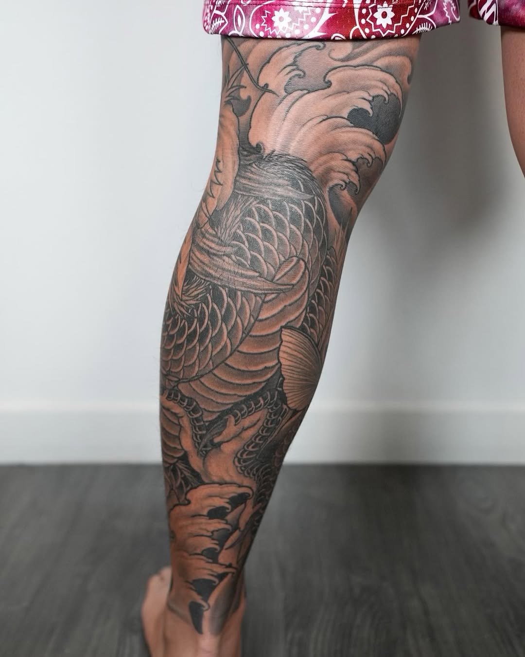 Koi fish and waves Japanese tattoo on the calf by Derek (Nghia) Chung