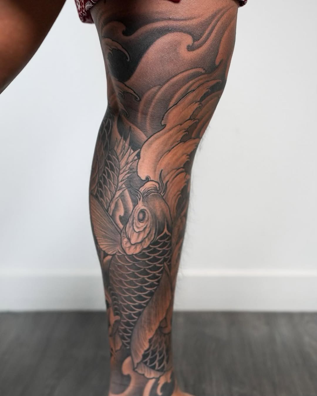 Koi fish and waves Japanese tattoo on the calf by Derek (Nghia) Chung