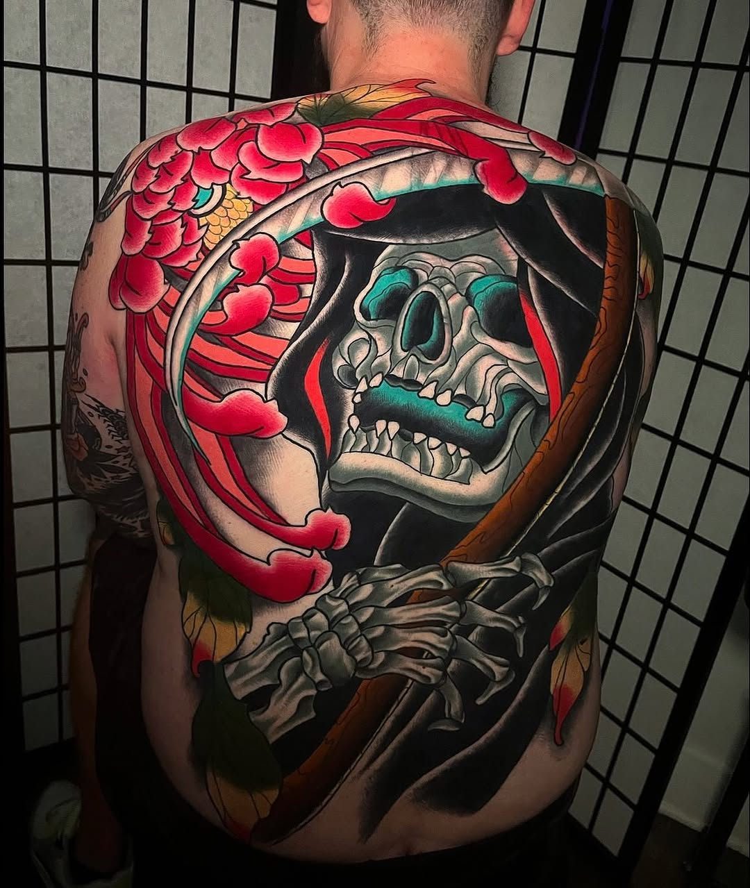 Grim reaper with chrysanthemum dark art tattoo on the back by Mickey Putillo, Charlotte, North Carolina