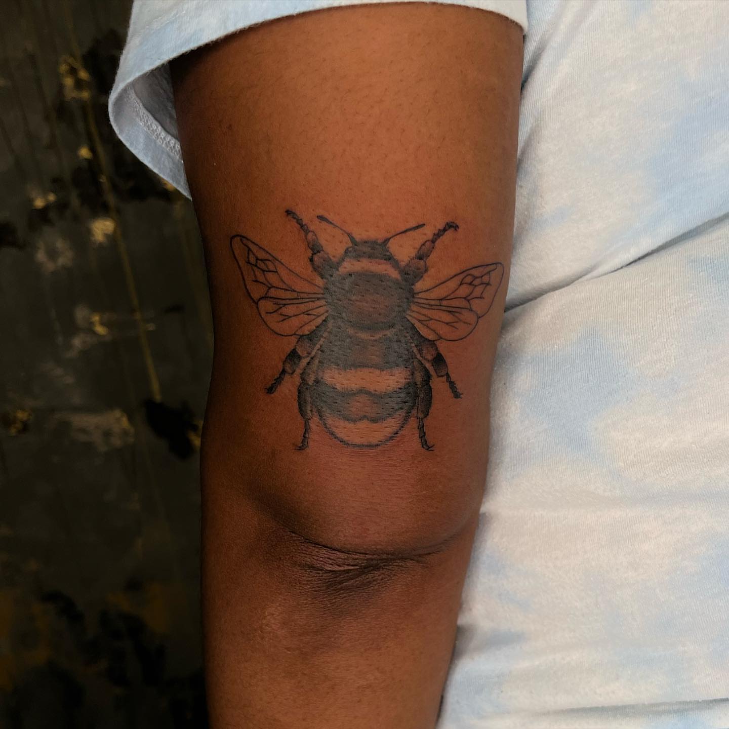 Bee black and grey tattoo on the forearm by ⊹ ࣪ ₊✩‧₊˚ 𝖘 𝖙 𝖊 𝖕 𝖍 𝖆 𝖓 𝖎 𝖊 ˚₊‧✩₊ ࣪ ⊹