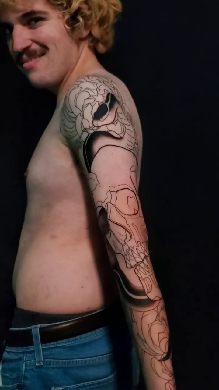 Skull and snake sleeve Japanese tattoo on the upper arm by Dennis Alejandro