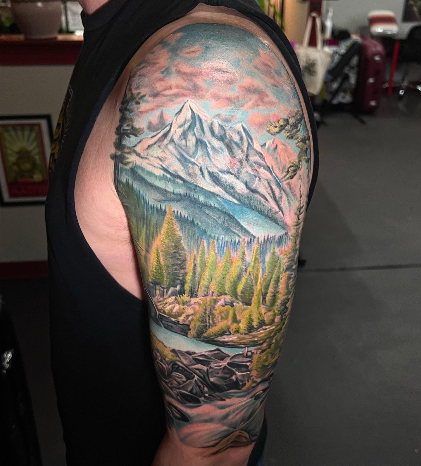 Mountain landscape realism tattoo on the forearm by Josh Green