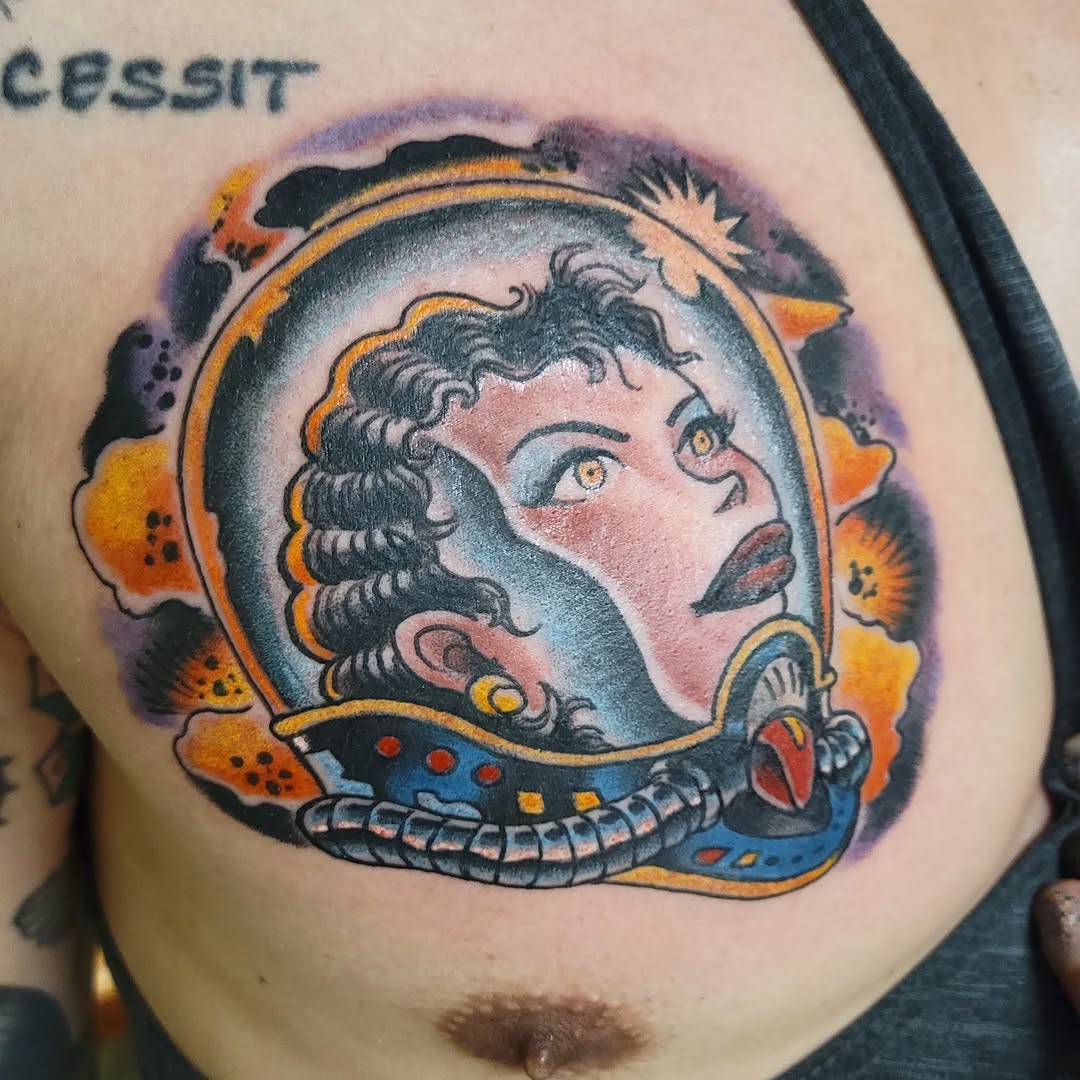 Woman in astronaut helmet neo-traditional tattoo on the chest by Mark Harada, Hoboken, New Jersey