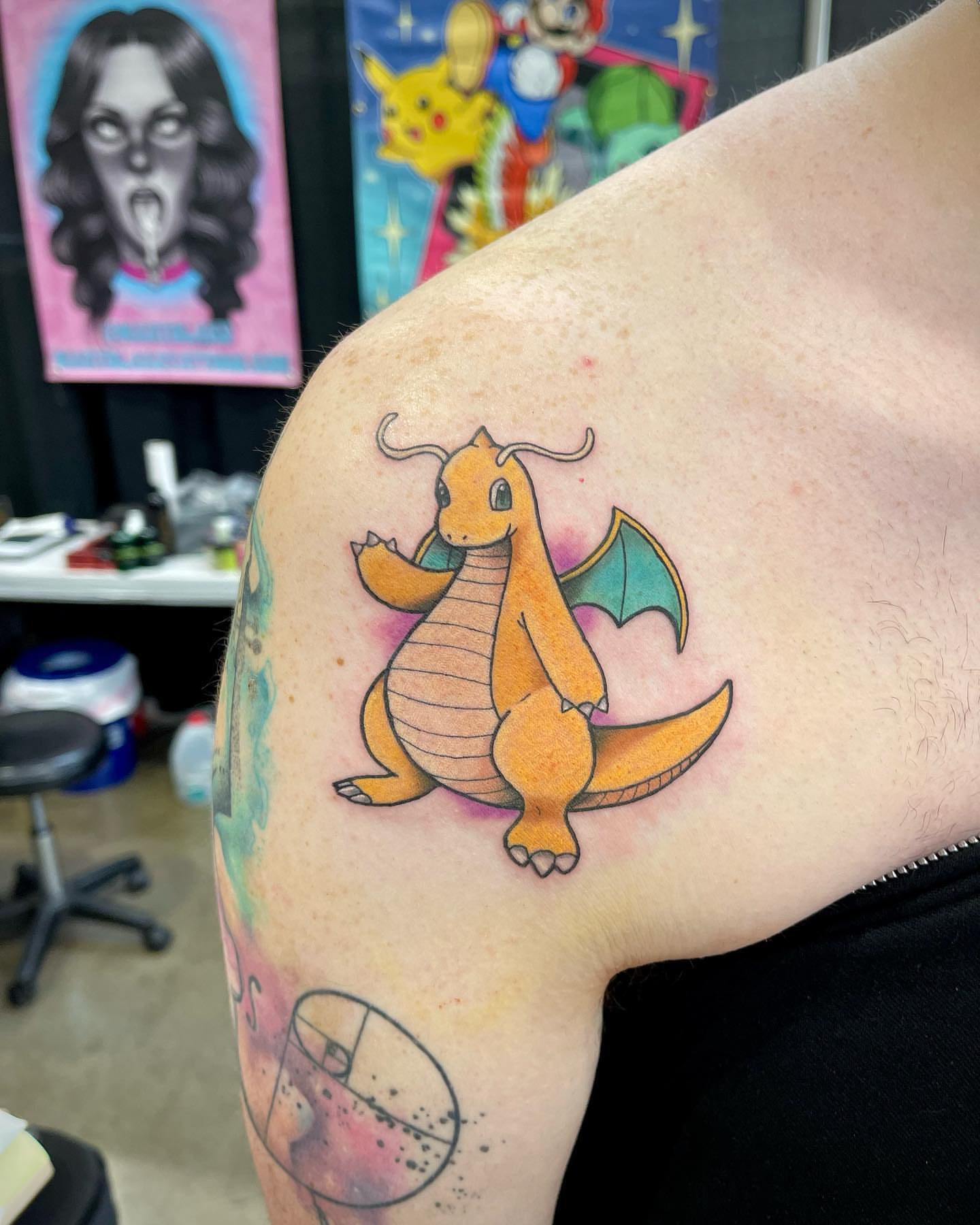 Charizard new school tattoo on the upper arm by Jake Snoddy, Franklin, Tennessee