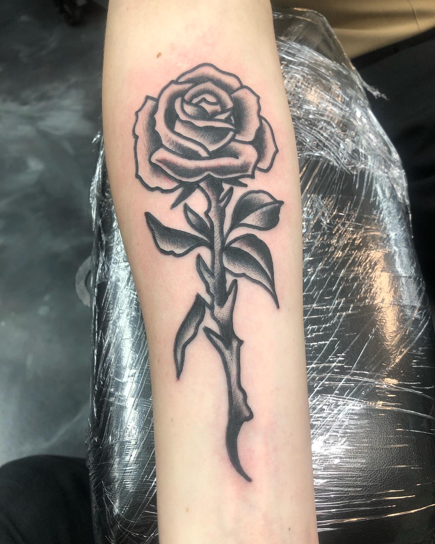 Rose black and grey tattoo on the forearm by Brent G