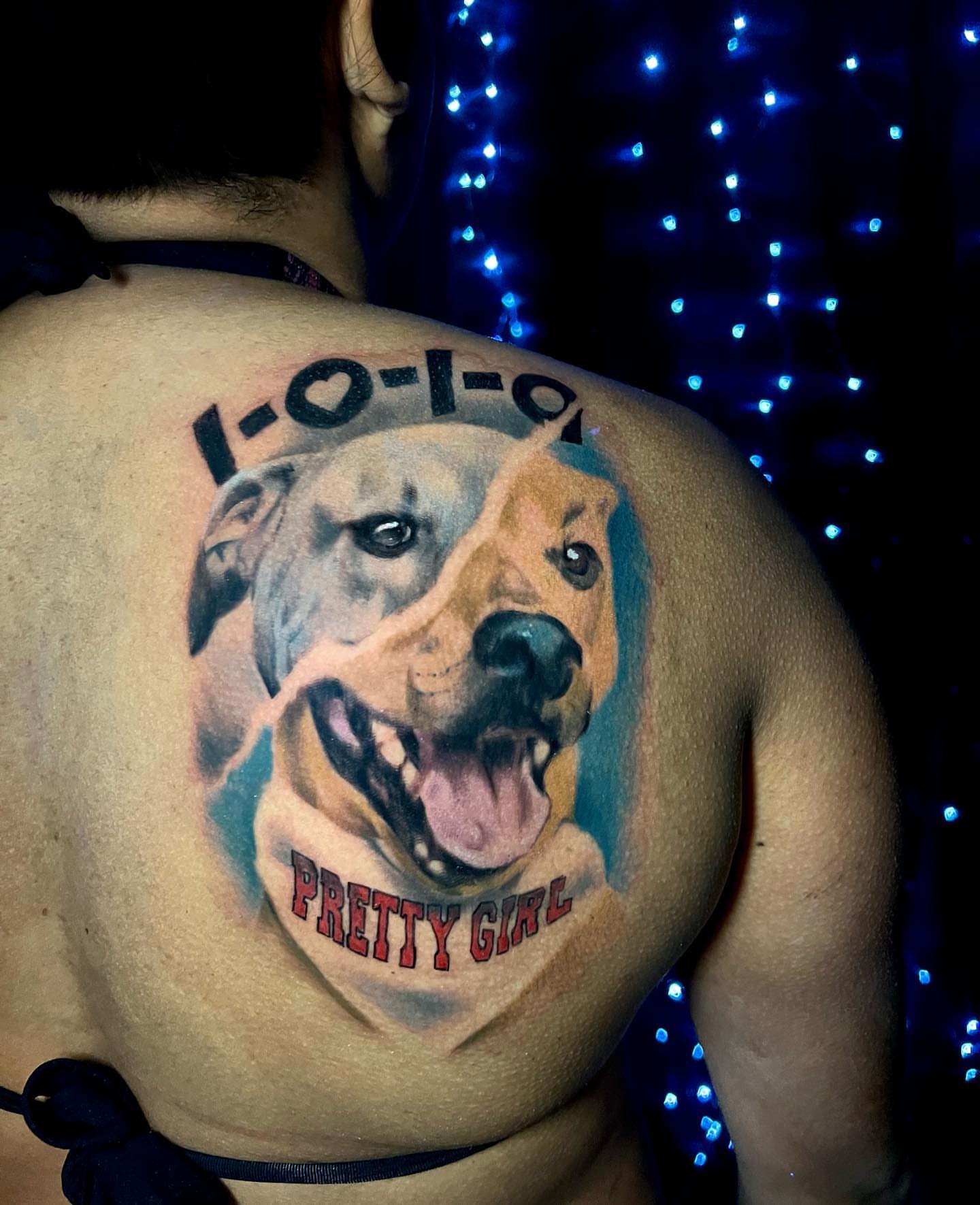 Dog and text realism tattoo on the back by Travis Thorpe