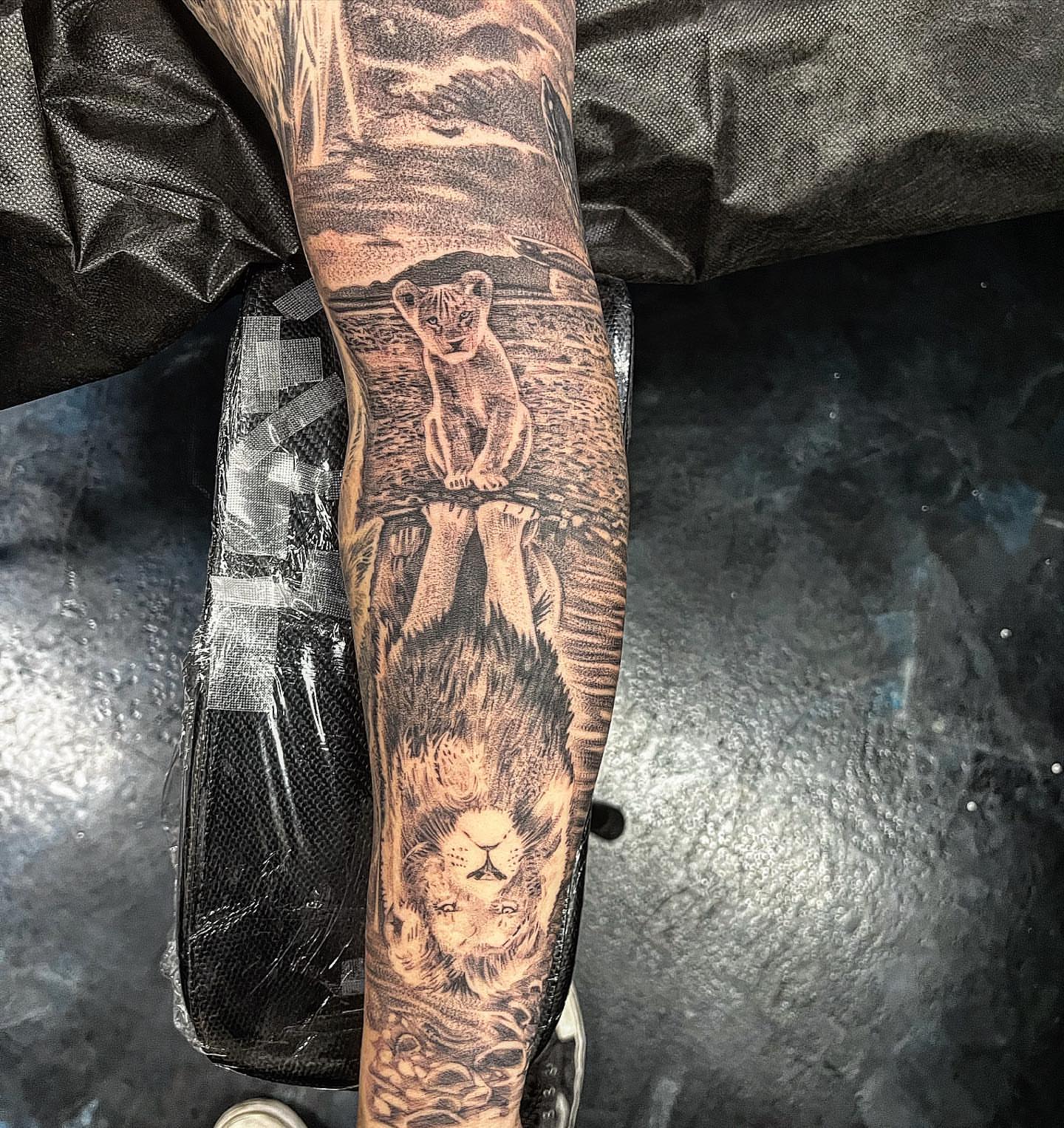 Lion and cub dotwork tattoo on the forearm by Creeper tattoo