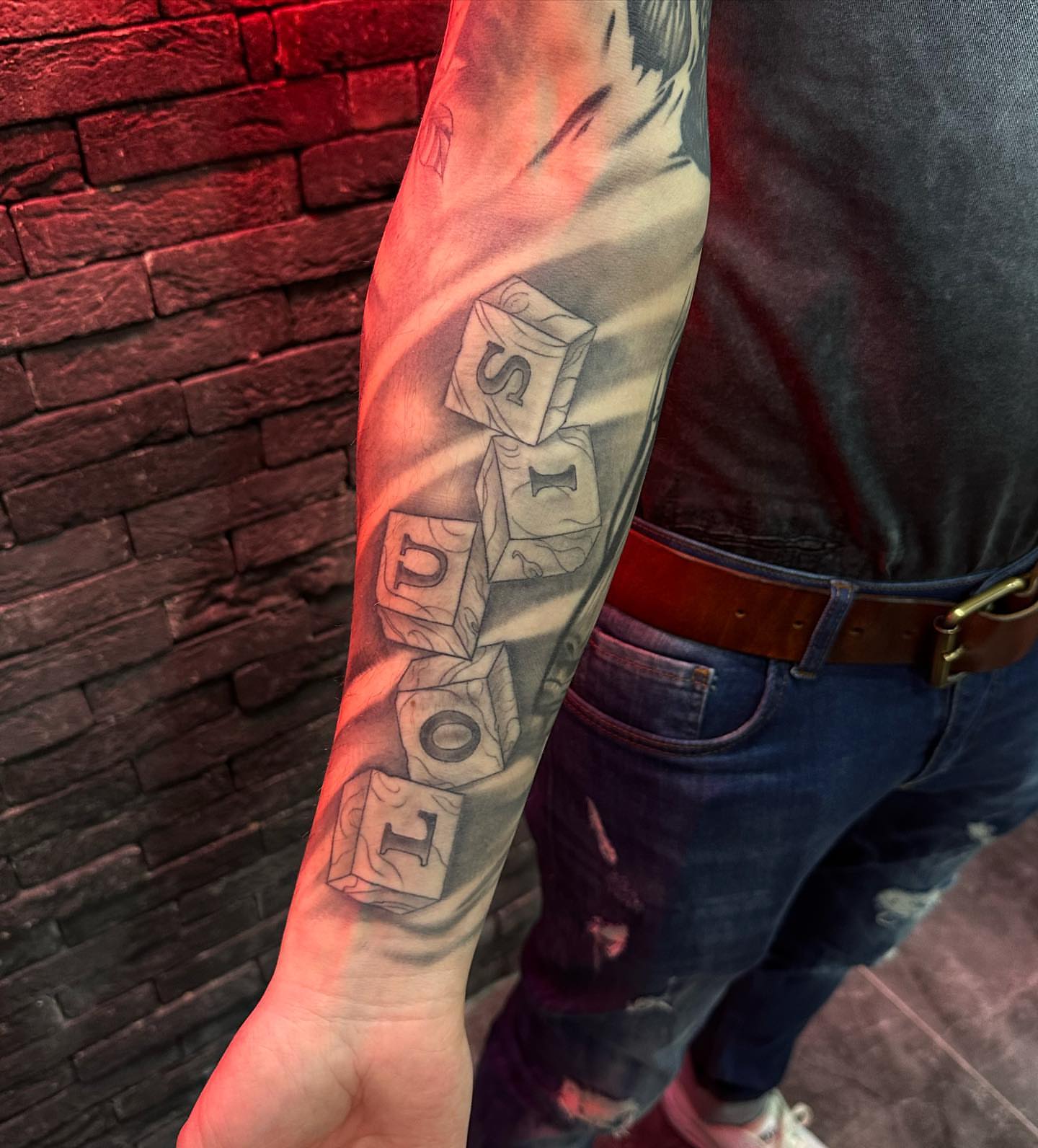 Dice black and grey tattoo on the forearm by Tattoo Artist πΊπΈ