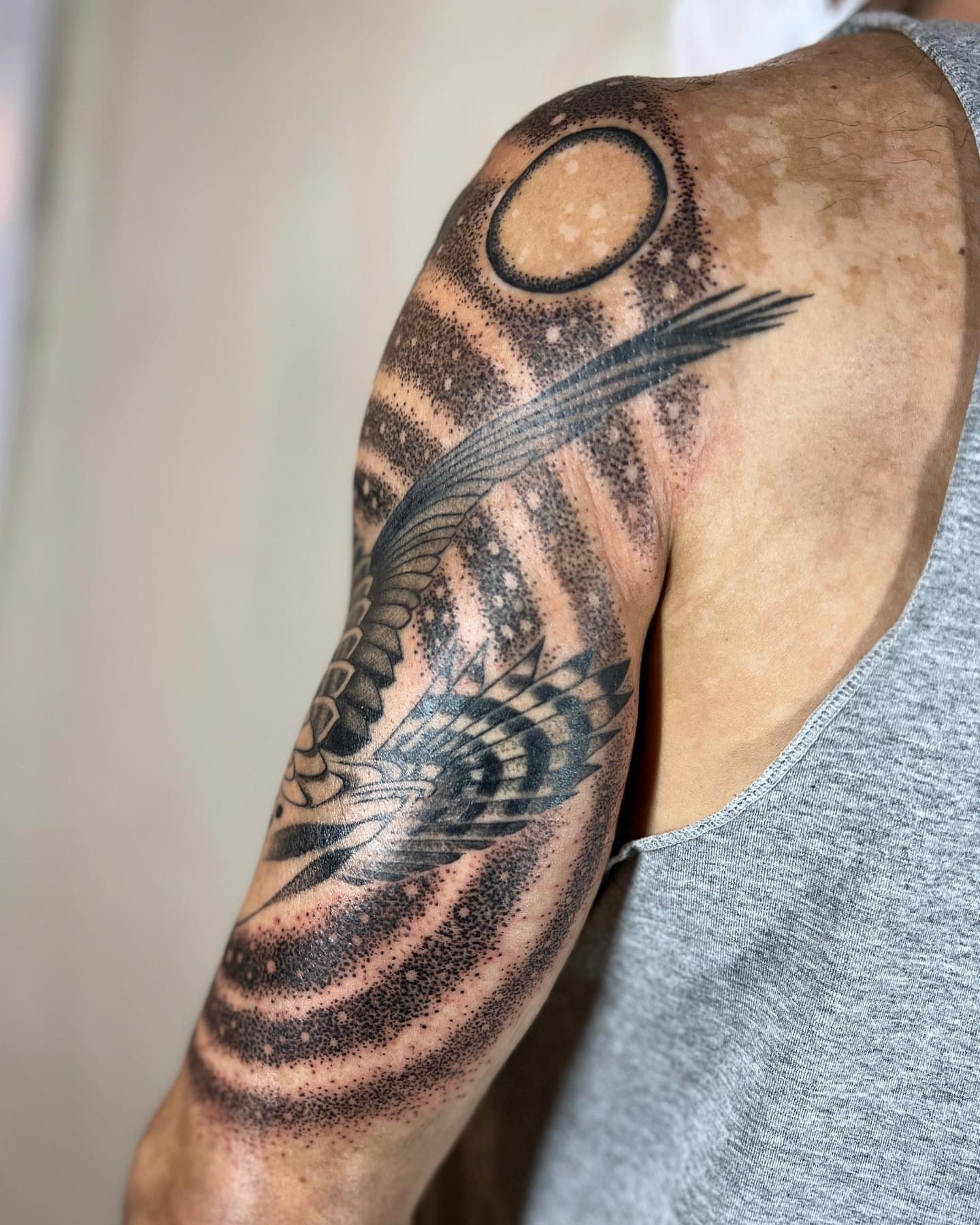 Bird and sun dotwork tattoo on the upper arm by 👽 Kat 👽, San Francisco, California