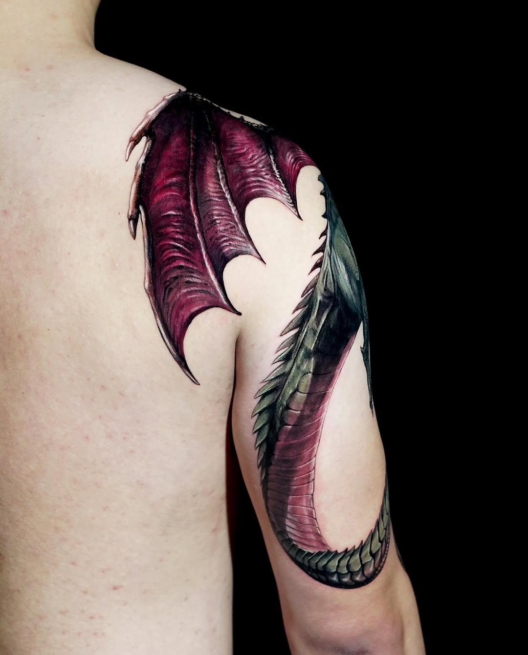 Dragon wing and tail watercolor tattoo on the shoulder by Eun, Toronto, Ontario
