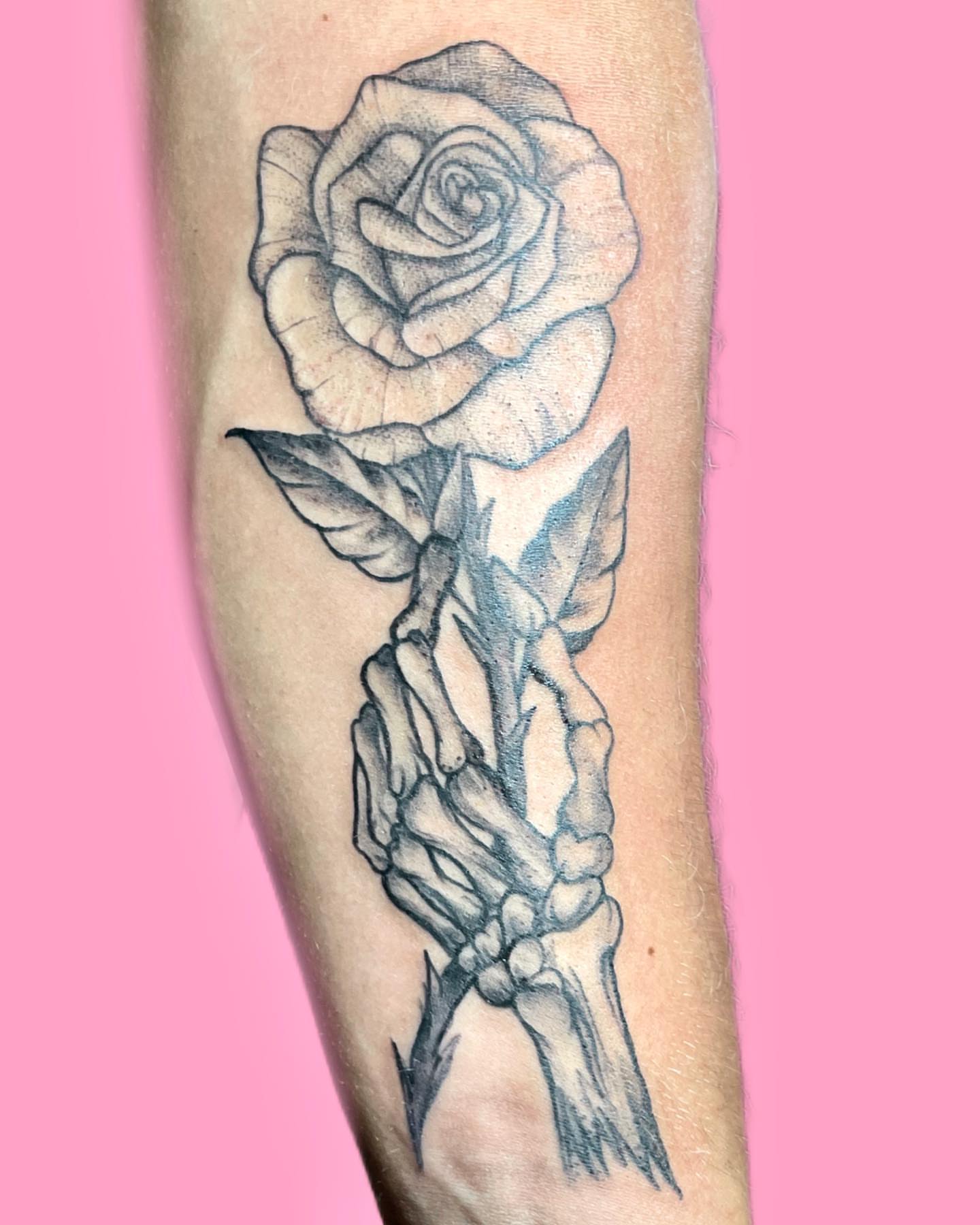 Rose and skeleton hand dotwork tattoo on the forearm by π©ππ π