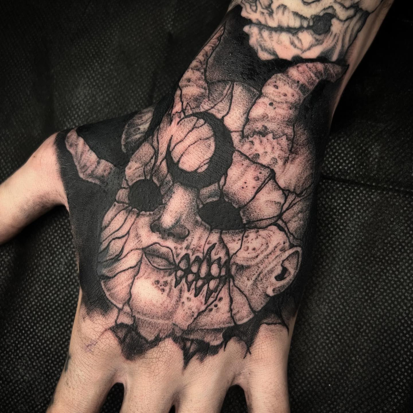 Skull dotwork tattoo on the hand by Kyle Black