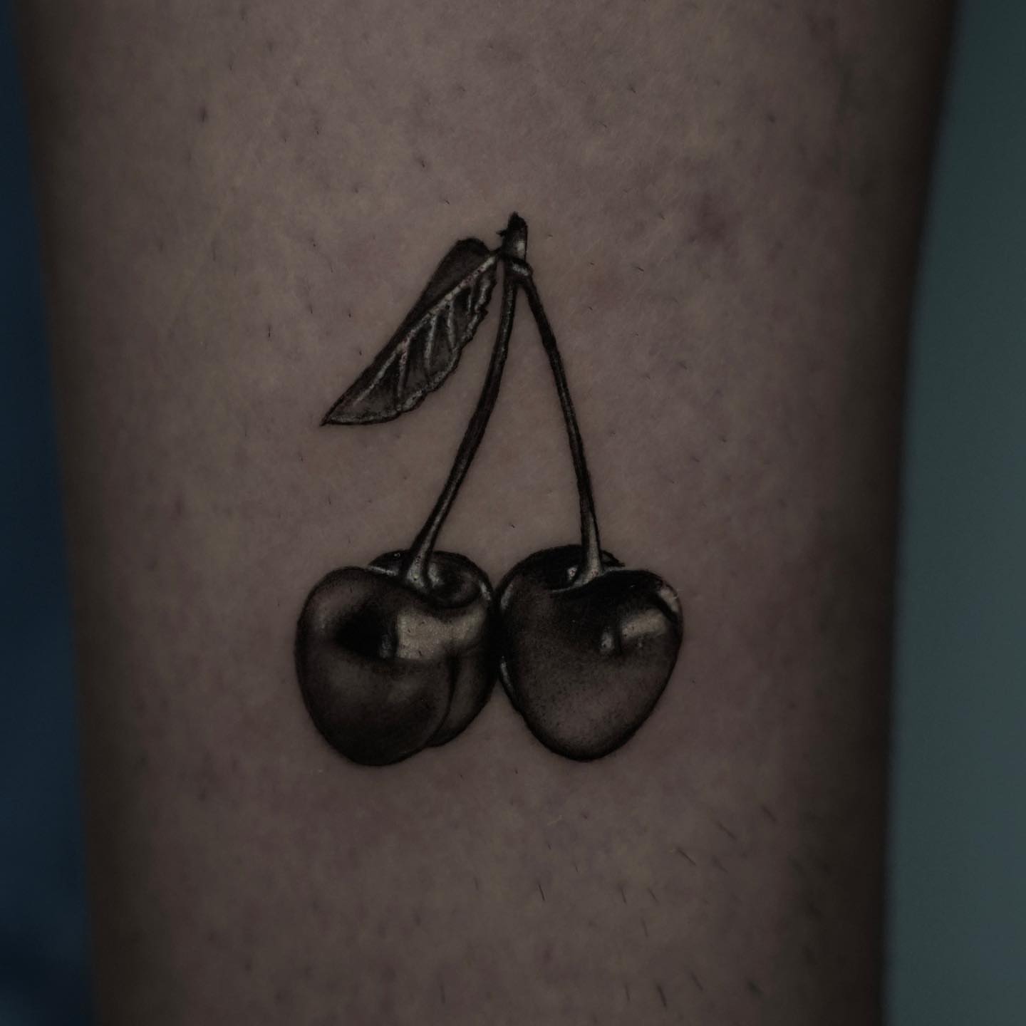 Cherries black and grey tattoo on the forearm by Dallas Tattoo Artist
