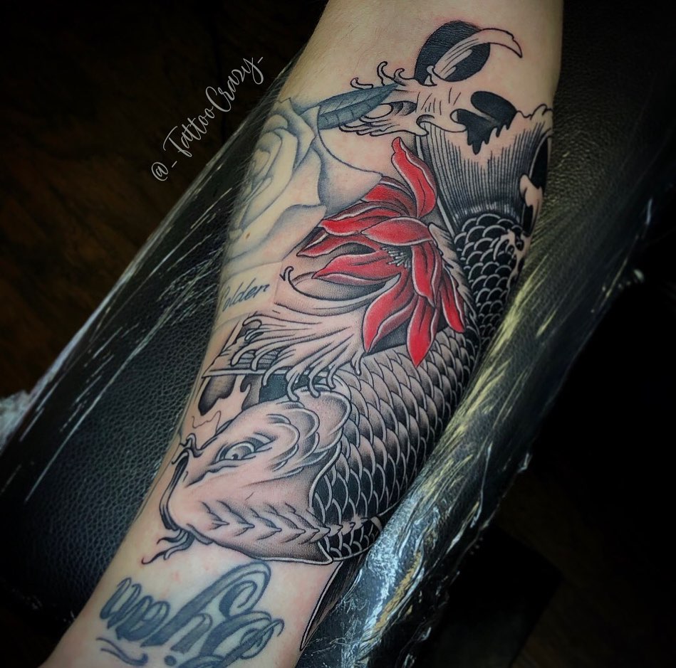 Koi fish and lotus flower American traditional tattoo on the forearm by TattooCrazy🎭