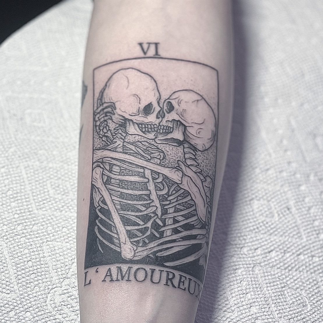 L'amoureux realism tattoo on the forearm by Eric Axle
