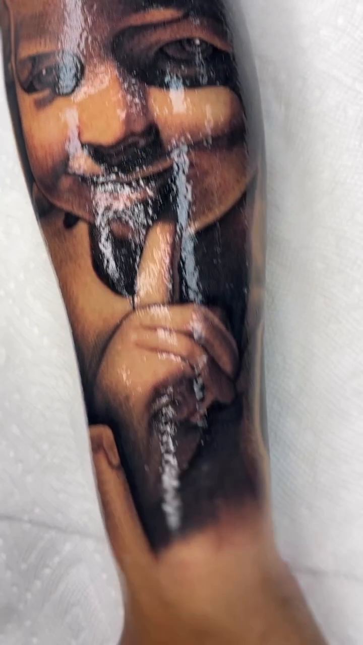 Cherub with finger to lips realism tattoo by Joseph Alvarado