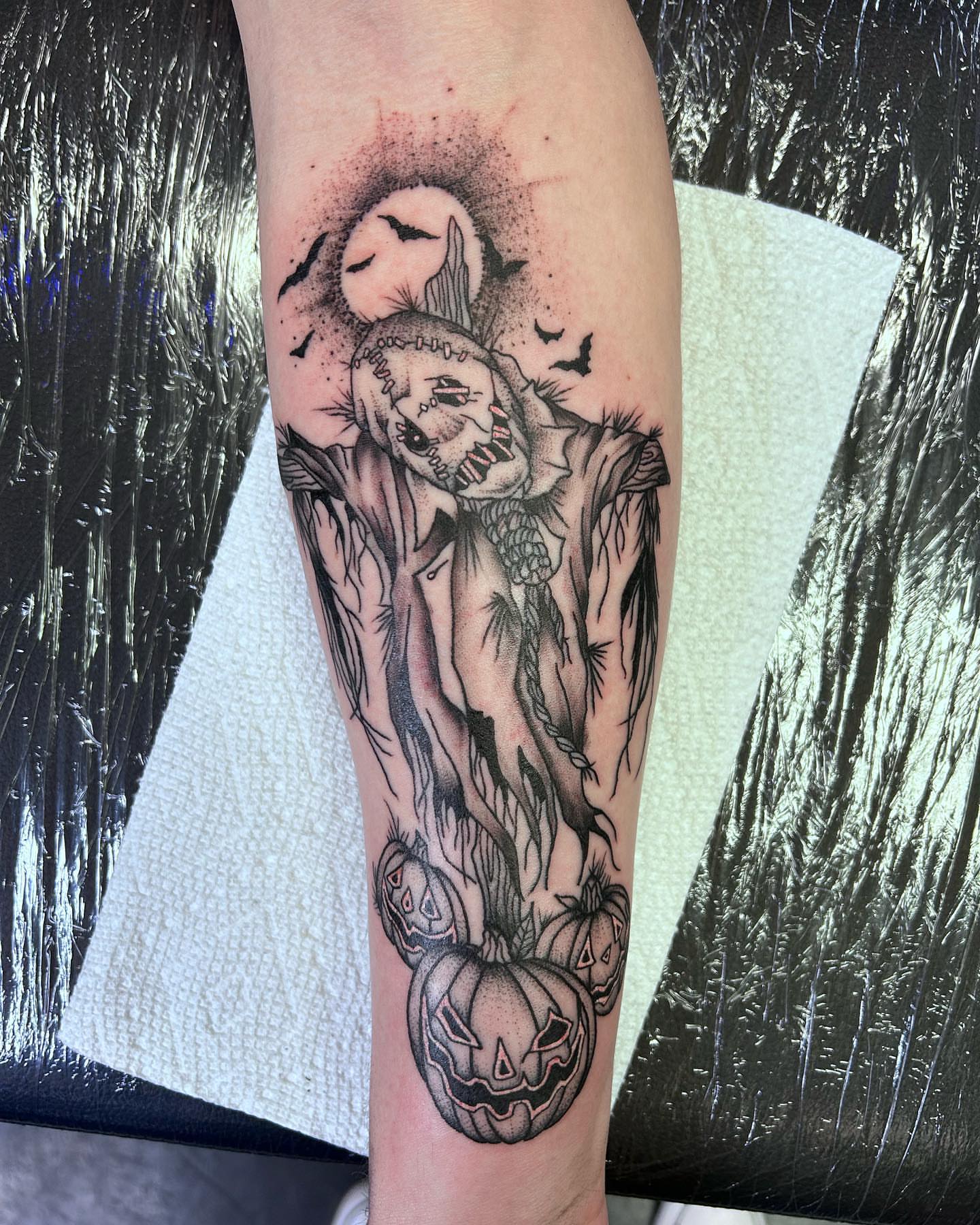 Jack-o'-lanterns and ghost dark realism tattoo on the forearm by Colby McClain