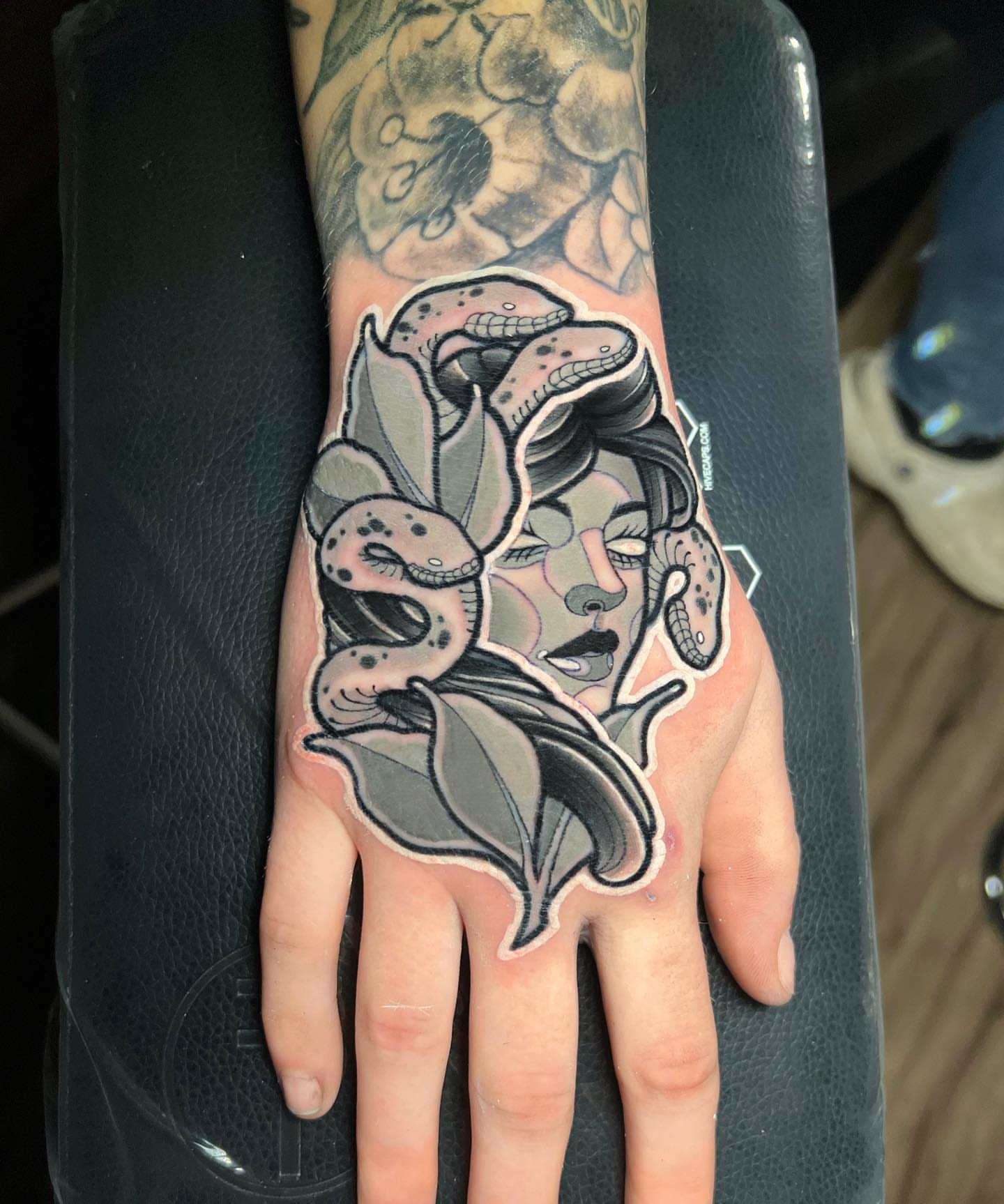 Snake and woman American traditional tattoo on the hand by Brian Horowitz