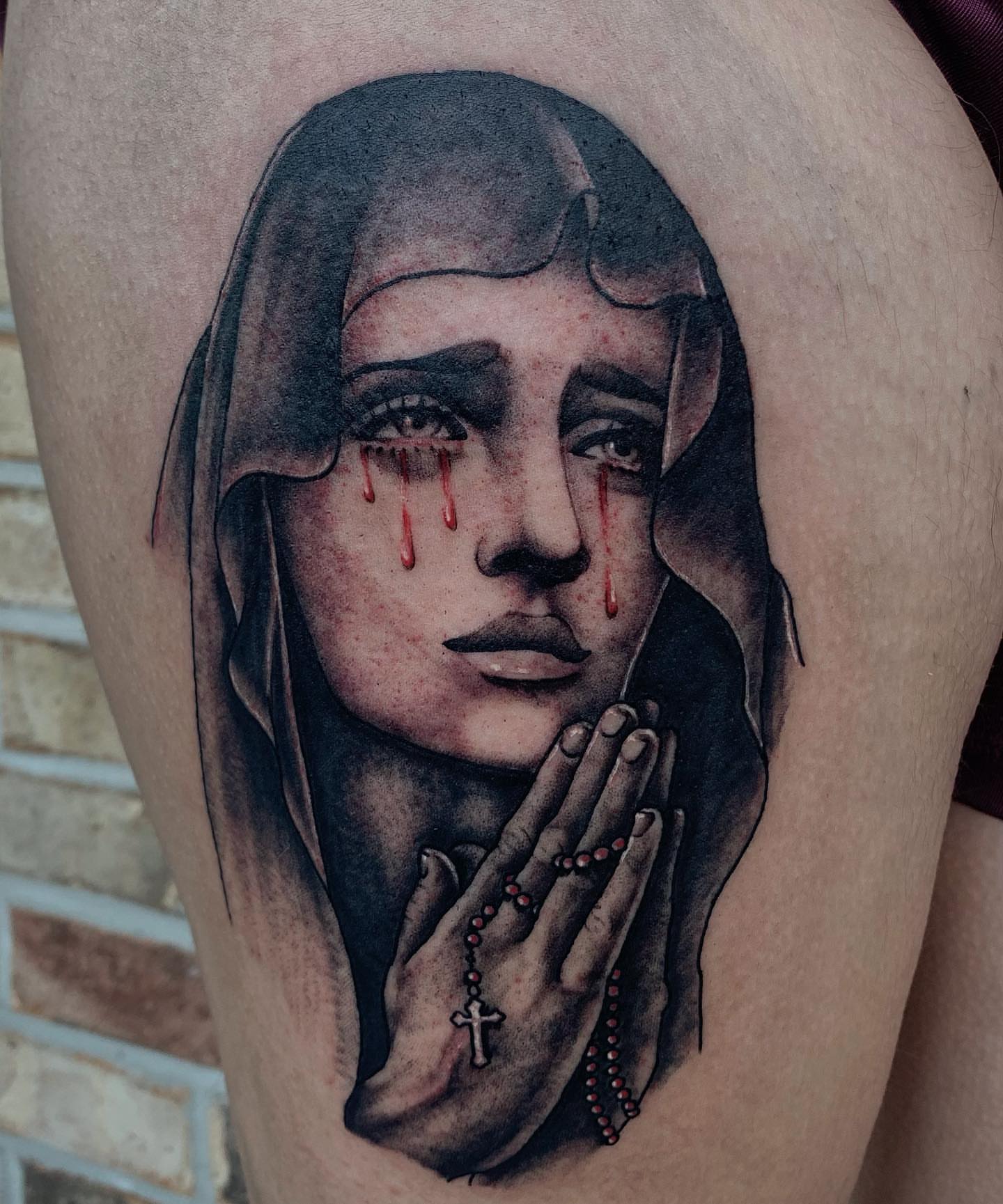 Tearful woman praying realism tattoo on the thigh by Storm