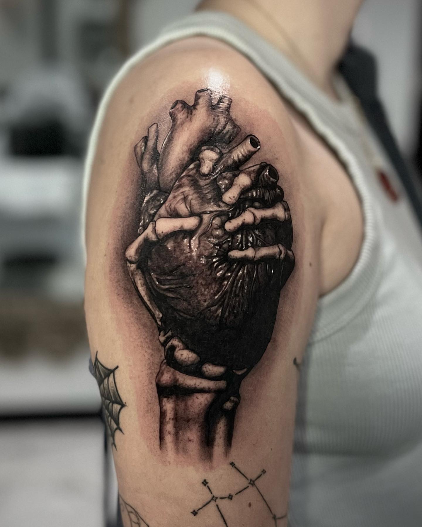 Heart with hands realism tattoo on the shoulder by Mia
