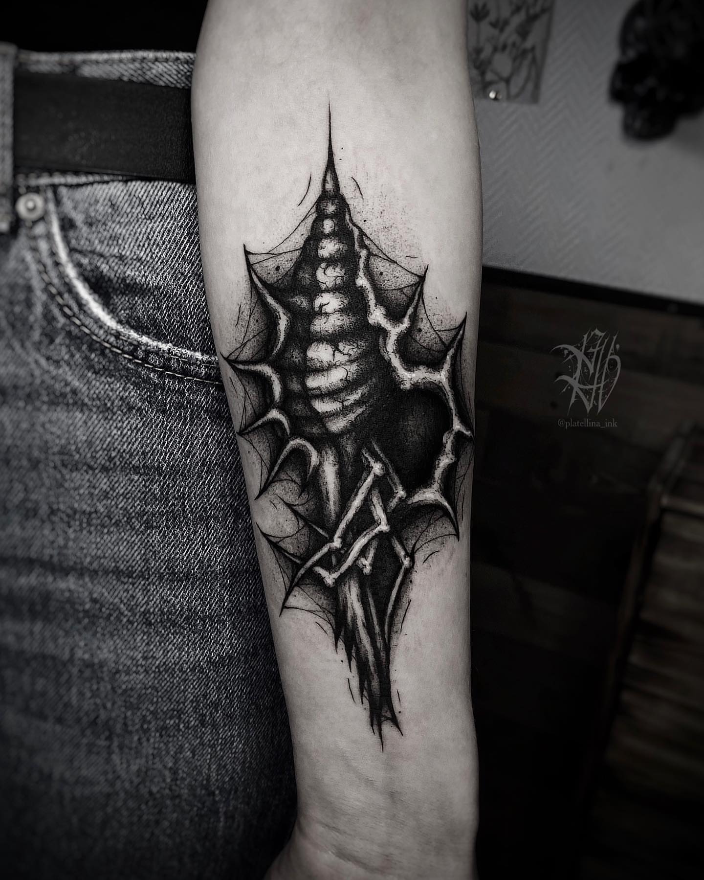 Spiderweb geometric tattoo on the forearm by Dark Gothic Tattoo
