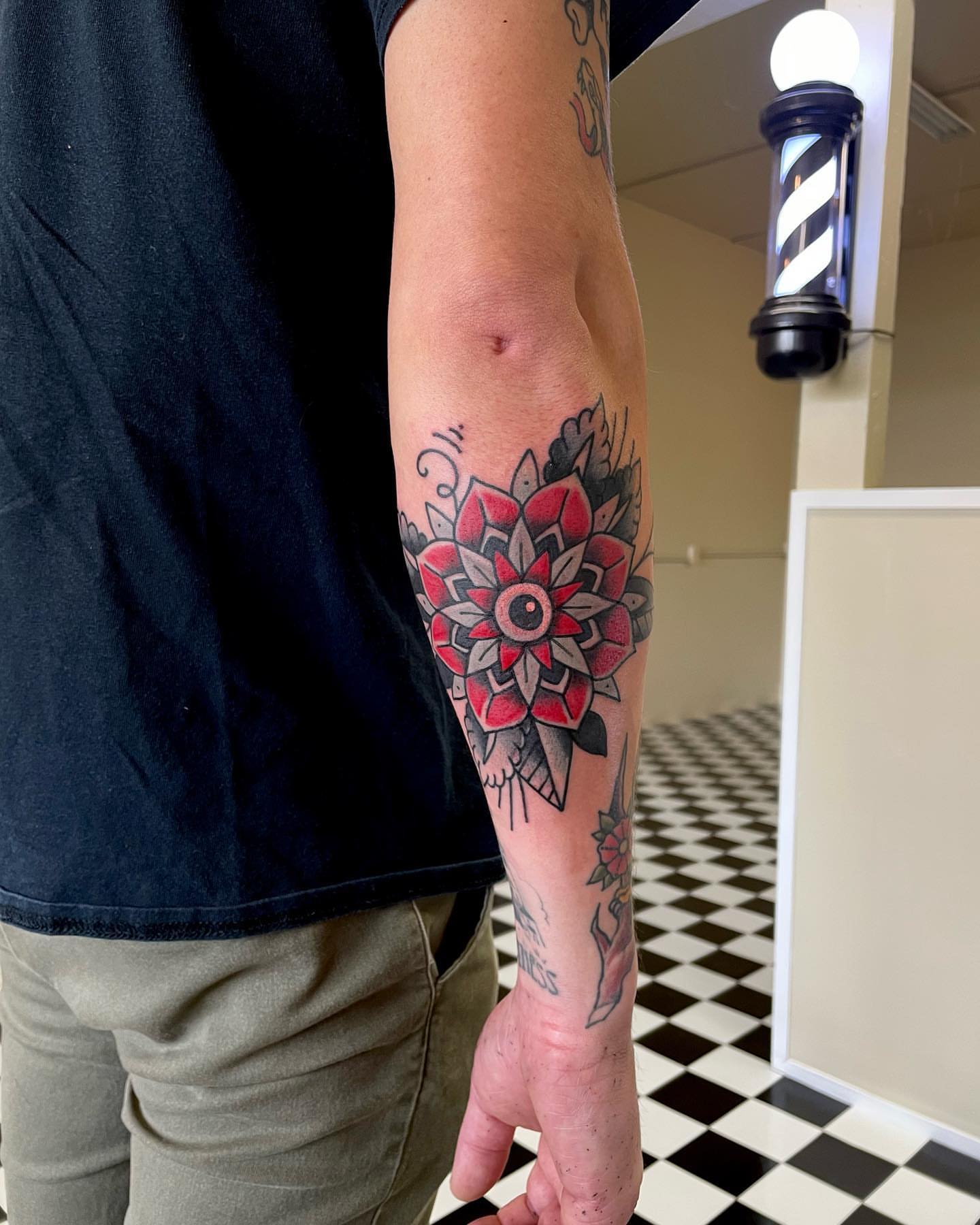 Floral mandala American traditional tattoo on the forearm by Don Robison