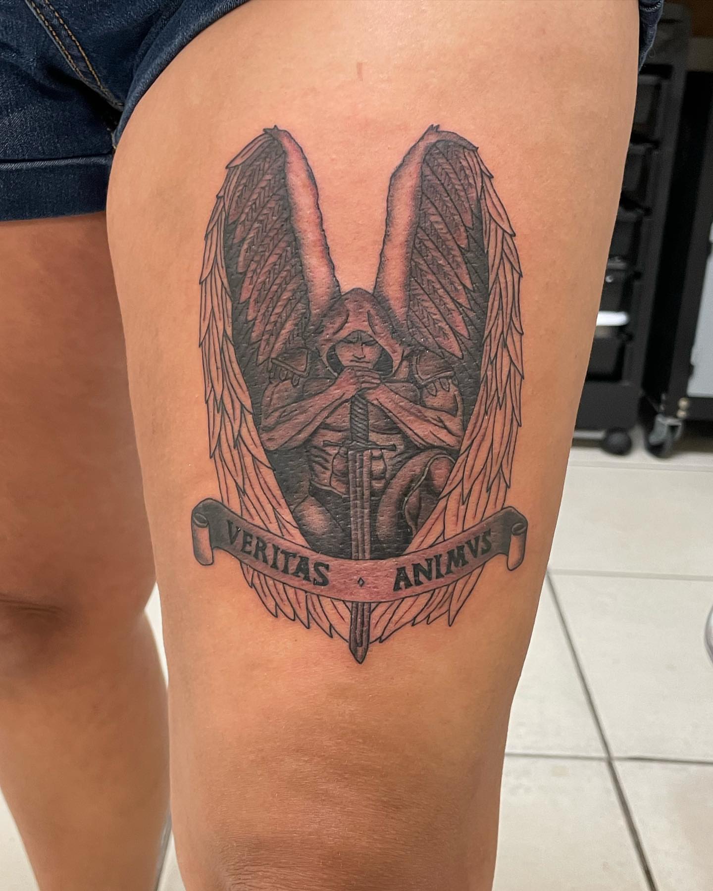 Angel with sword black and grey tattoo on the thigh by Las Vegas Tattoo Artist