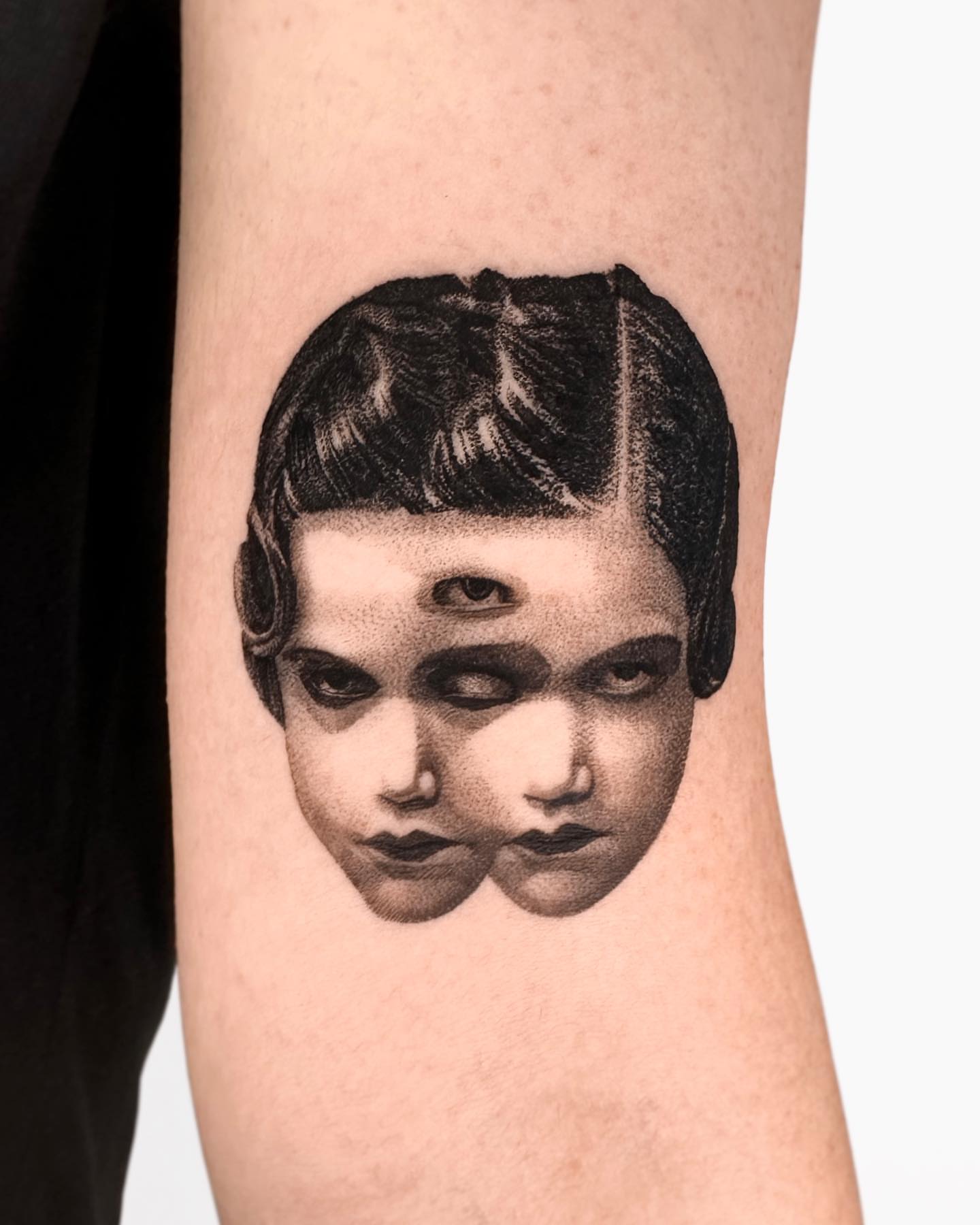 Double face dotwork tattoo on the forearm by Saru