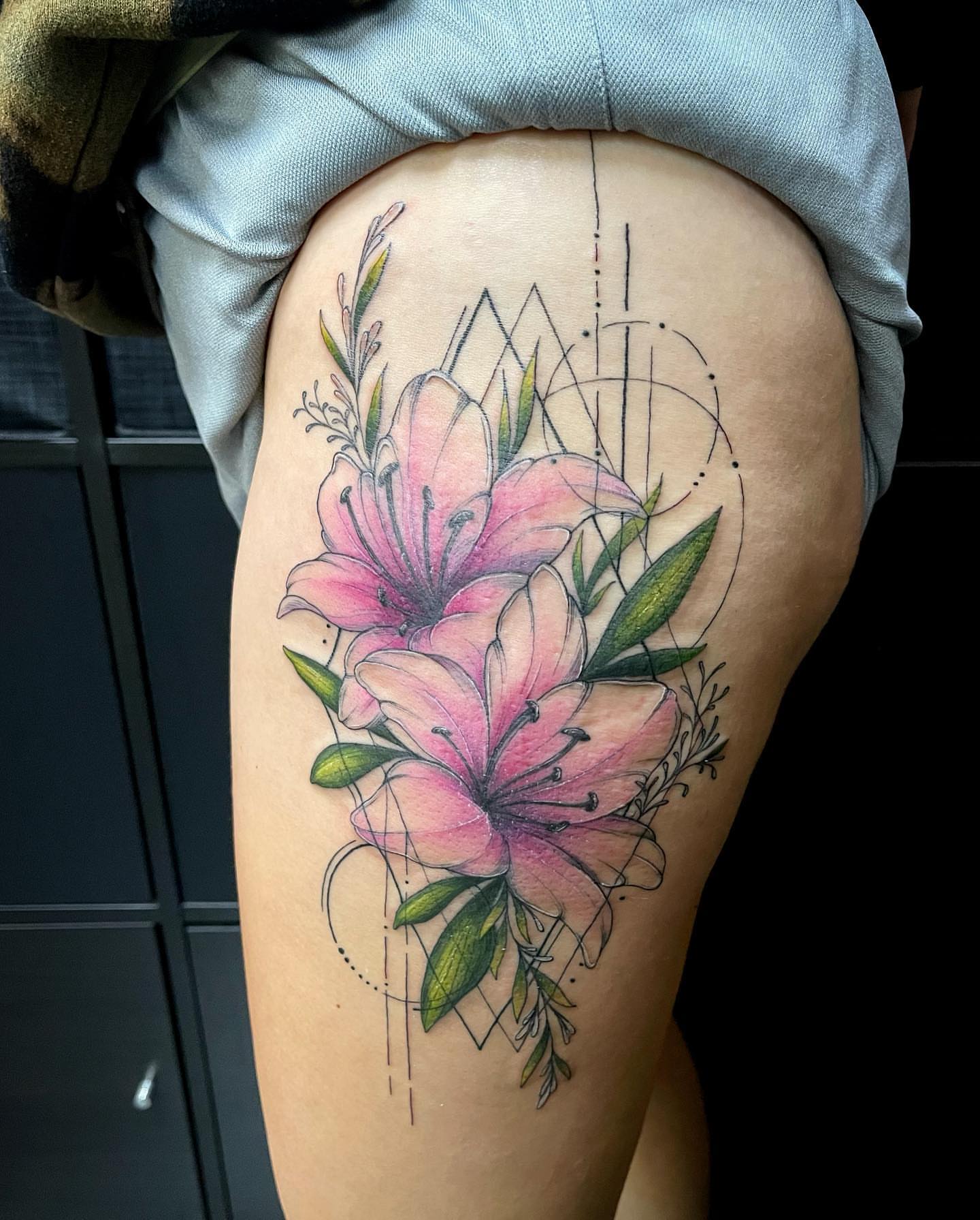 Lilies realism tattoo on the thigh by Lexx Christine