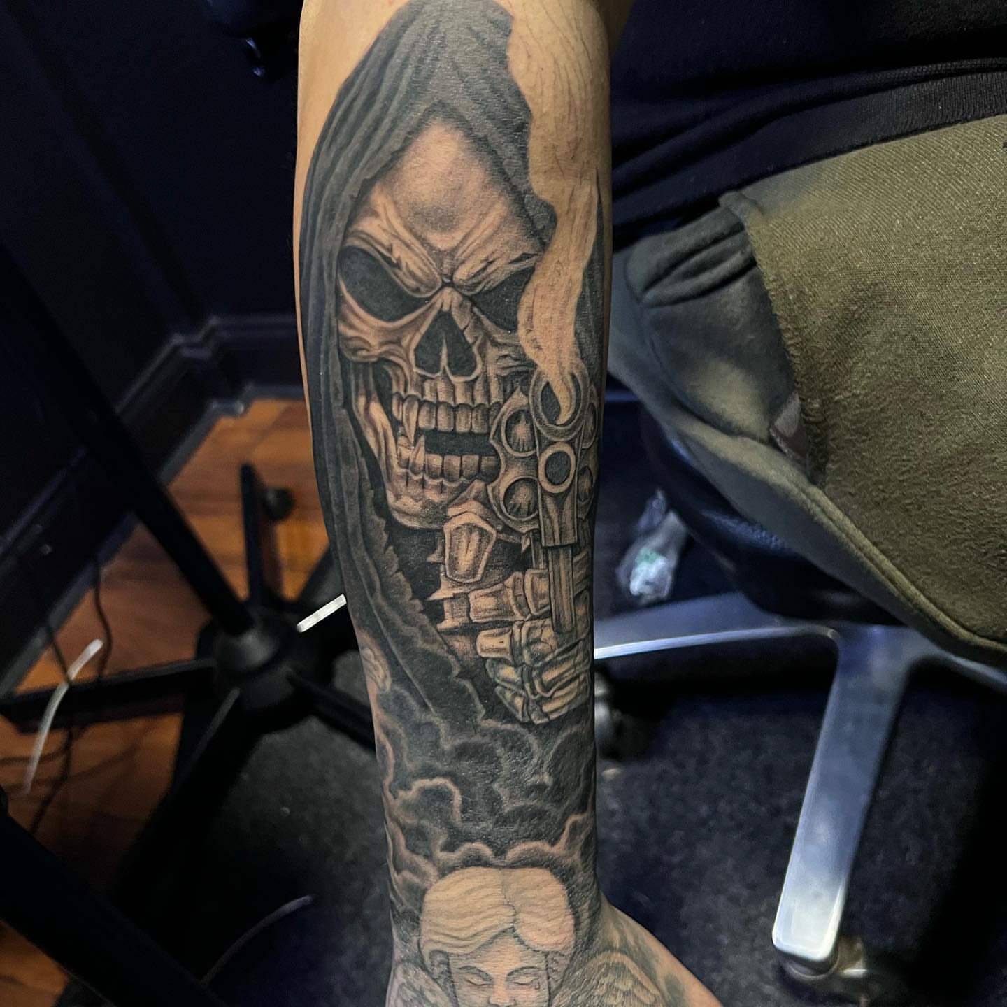 Skull with gun realism tattoo on the forearm by JT Ink