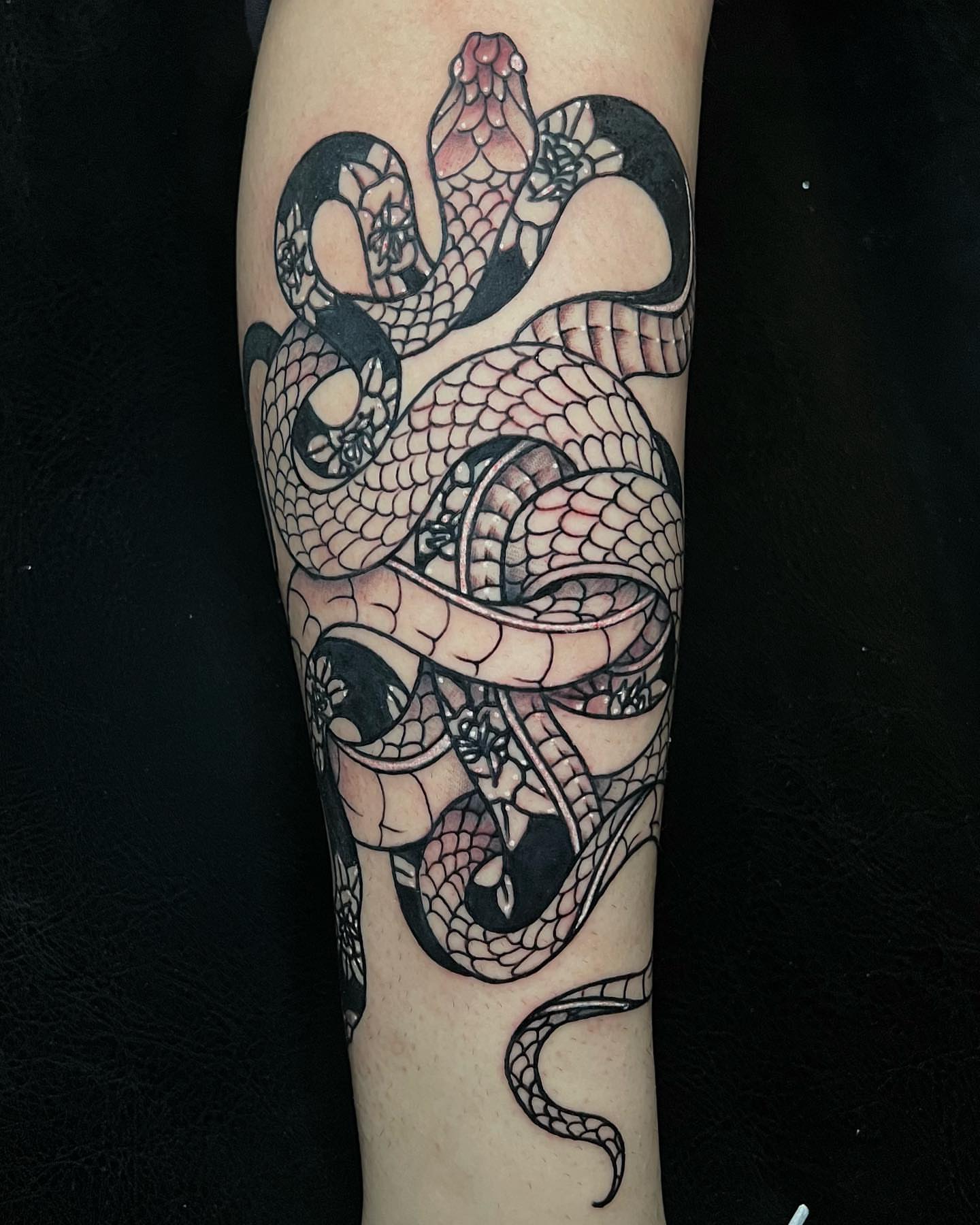 Snake black and grey tattoo on the forearm by Raul Ortiz