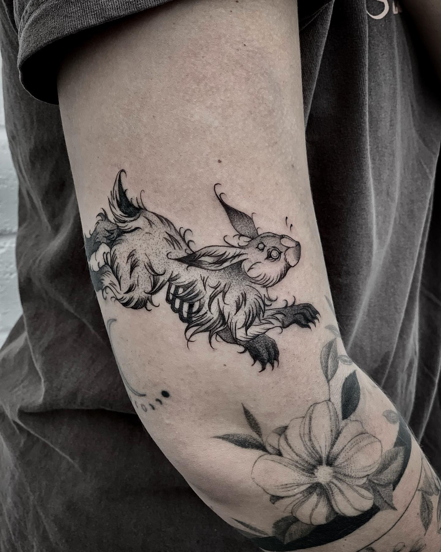 Fantasy creature black and grey tattoo on the forearm by Melanie
